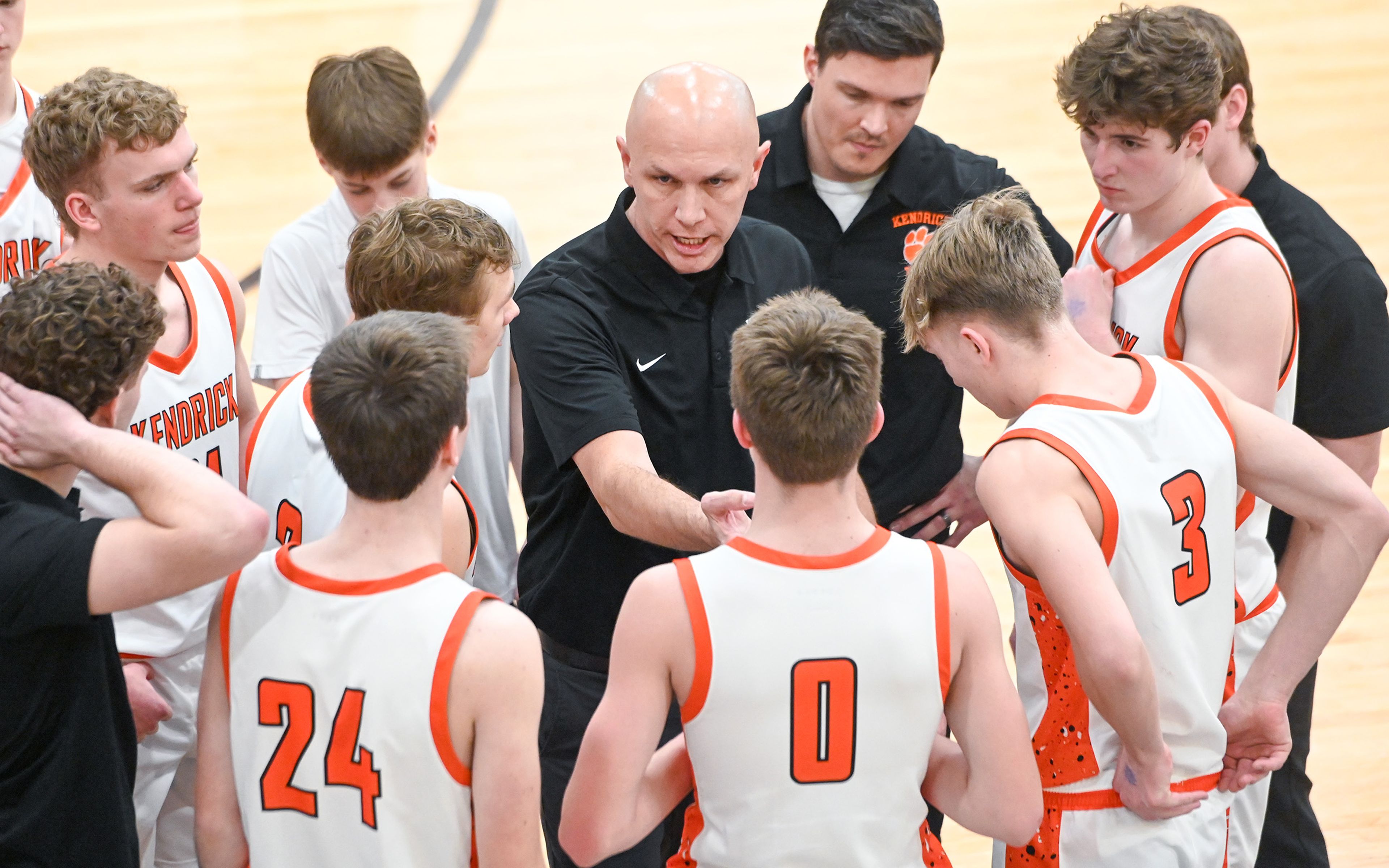 Kendrick head coach Steve Kirkland talks with players in a huddle during an Idaho 2A state tournament game against Grace on Friday in Caldwell, Idaho.