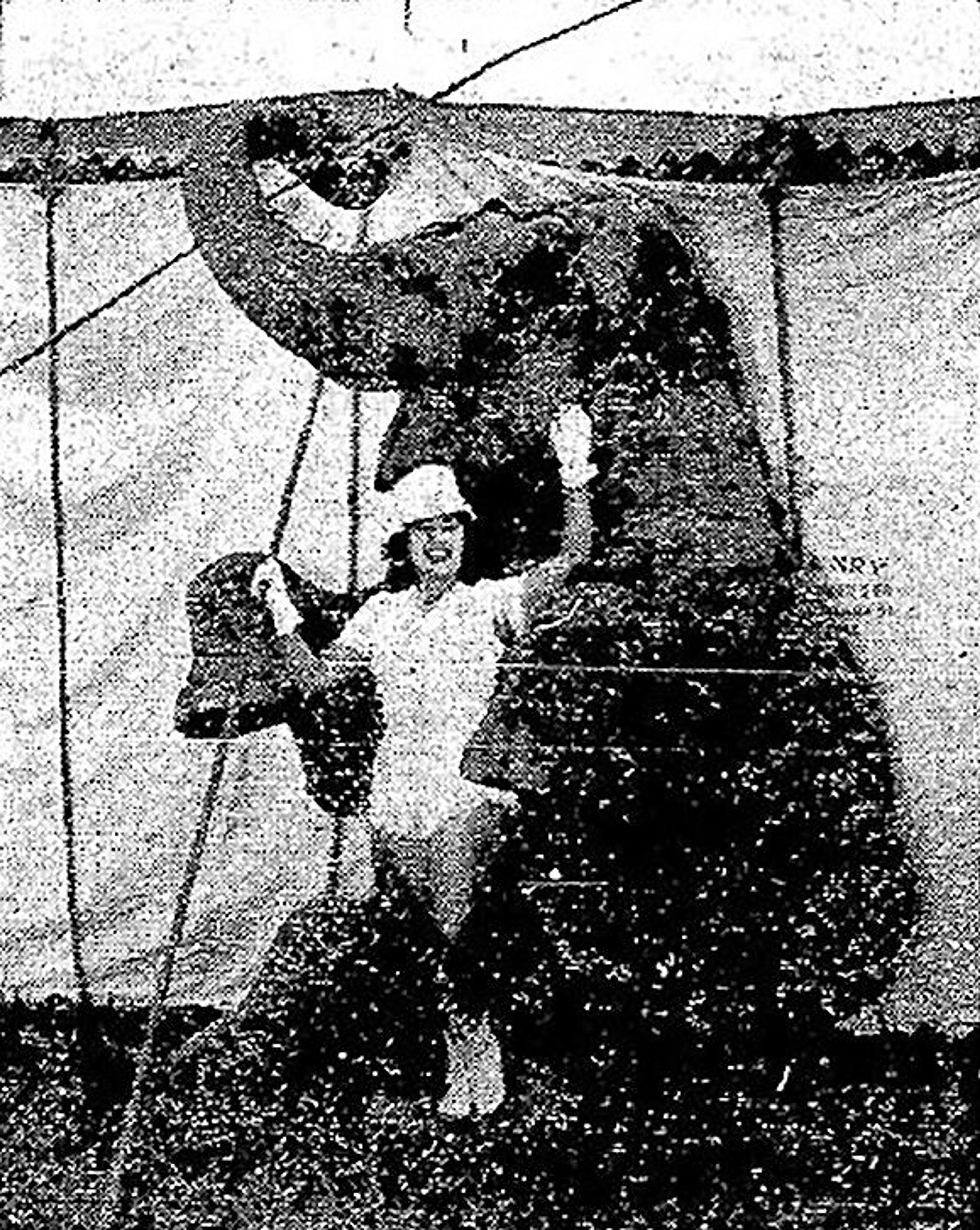 Betty Acevedo, pretty girl trainer, and "Old Dutch,” one of Arthur Bros. military elephants.