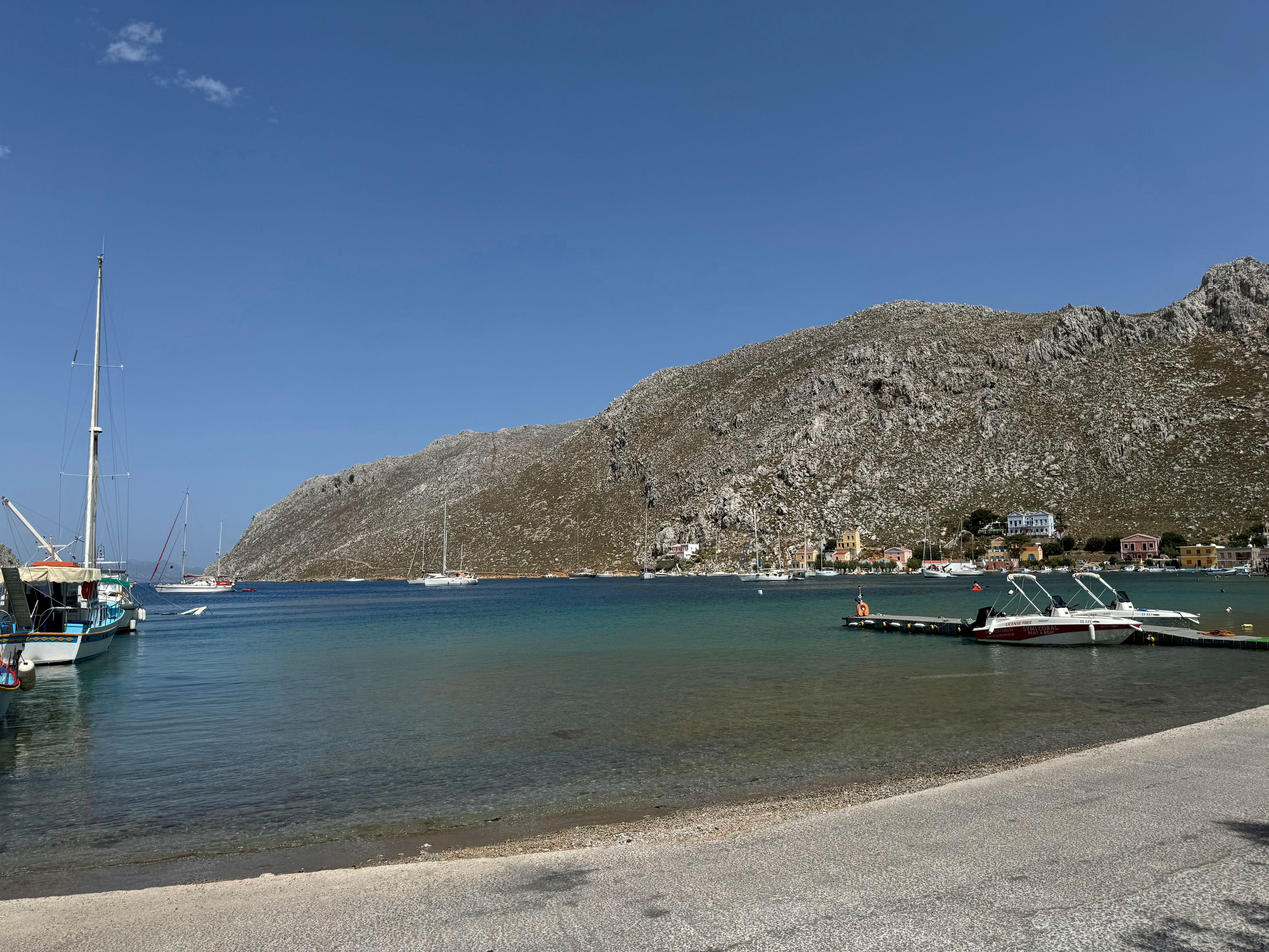 The small village of Pedi, where some reports indicate missing British doctor and TV presenter Michael Mosley was sighted, is seen on the southeastern Aegean Sea island of Symi, Greece, Friday, June, 7, 2024. Mosley went missing on Wednesday afternoon while on vacation on Symi, and authorities said a search and rescue operation that continued on Friday had found no trace of him.