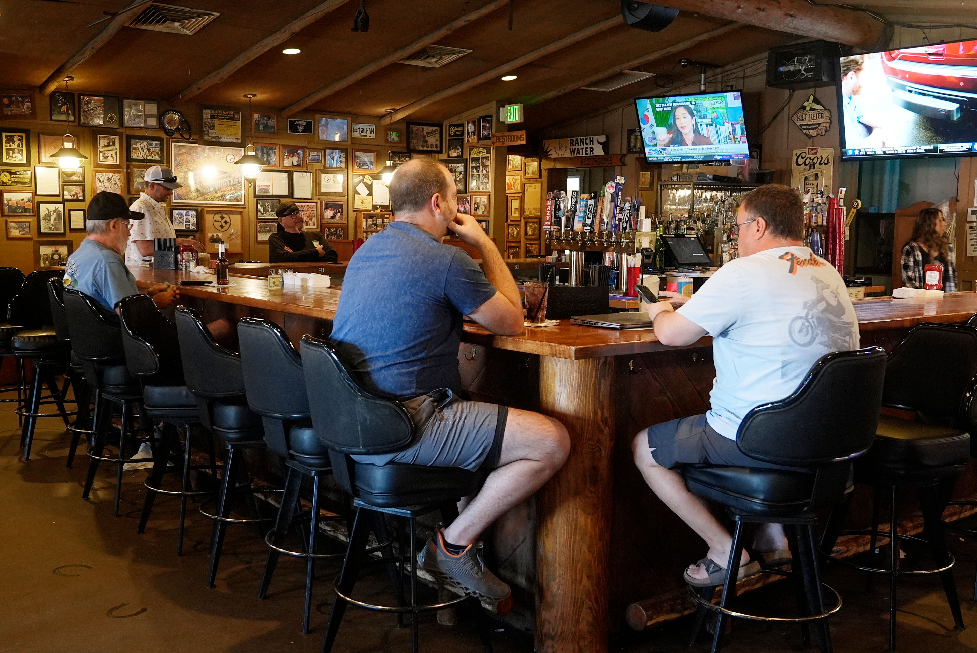 Patrons sit at the bar for lunch at Harold's Cave Creek Corral, regarding Arizona Prop 138 on minimum wage Thursday, Oct. 3, 2024, in Cave Creek, Ariz. (AP Photo/Ross D. Franklin)