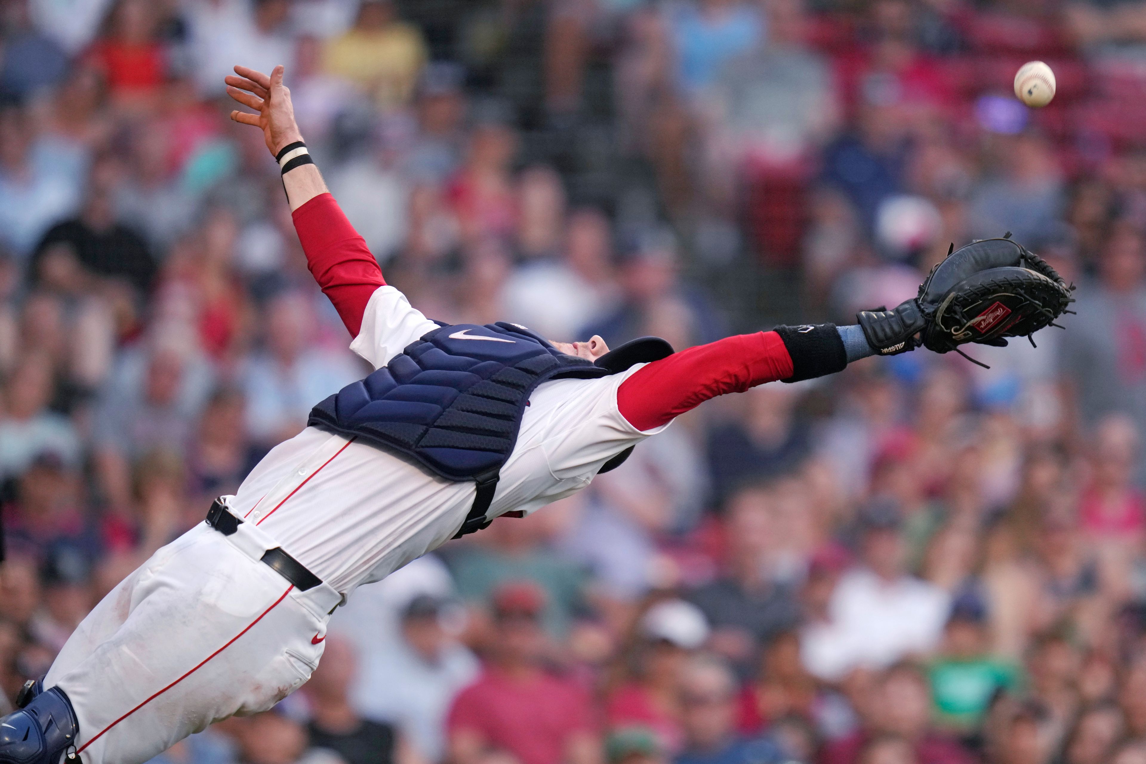 Boston Red Sox's Danny Jansen stretches back to make the play on a pop out by Seattle Mariners' Mitch Haniger during the ninth inning of a baseball game, Wednesday, July 31, 2024, in Boston. (AP Photo/Charles Krupa)