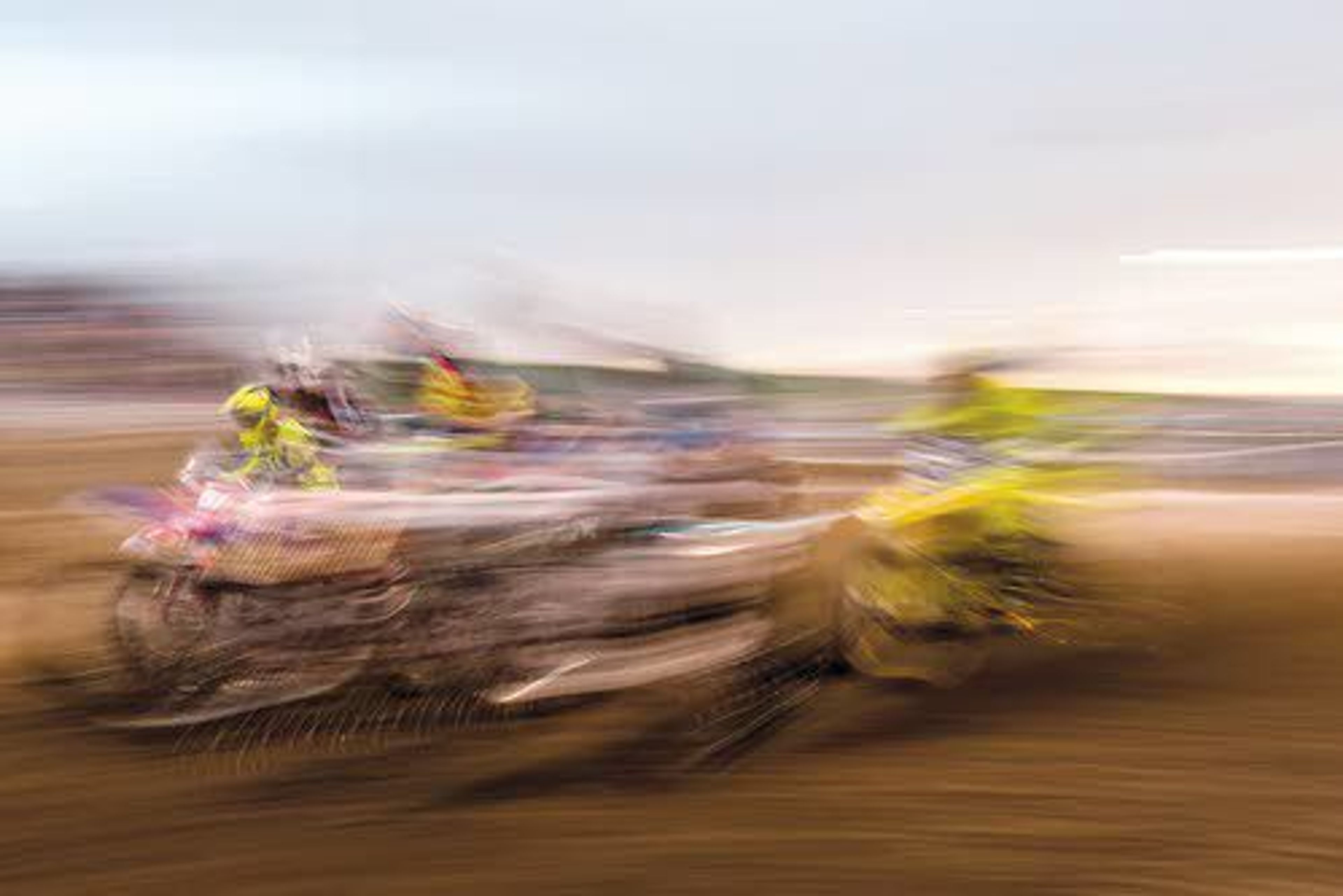 In this long exposure photo, racers leave the starting gate during 450 pro/250 intermediate qualifier race on Saturday night at the Lewiston Supercross event at the Lewiston Roundup Grounds.