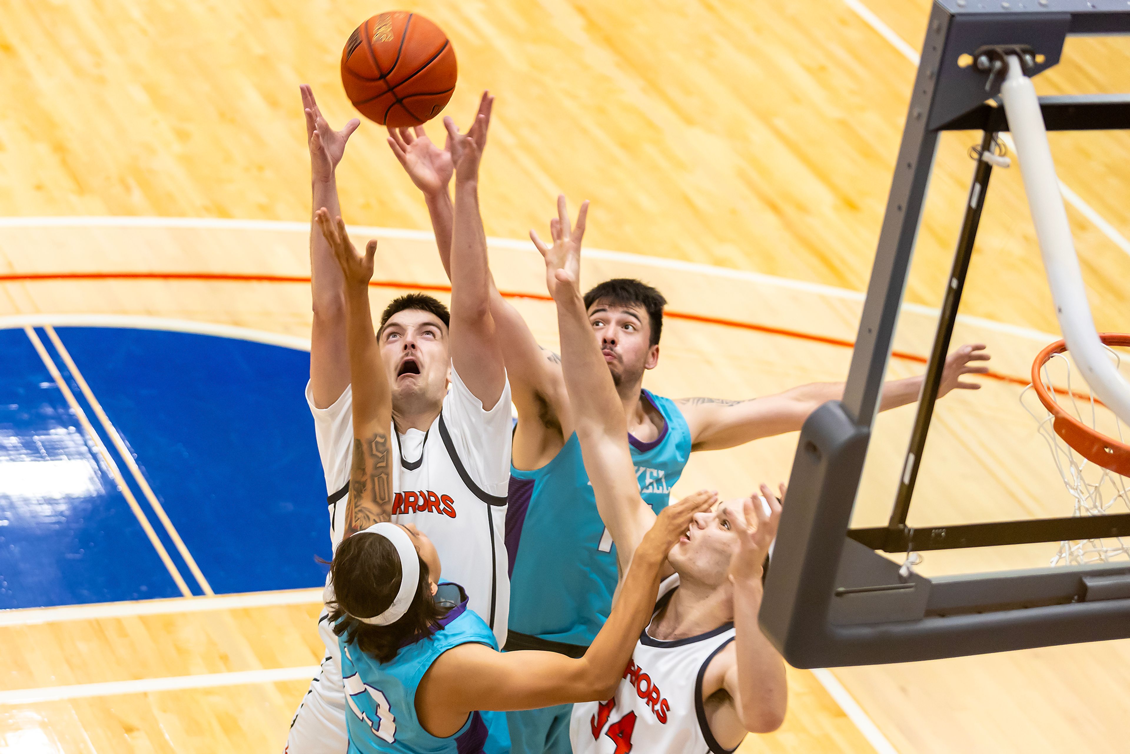 Lewis-Clark State guard Caden King prepares to grab a rebound over Haskell during the season opening game as part of Tribal Nations Weekend Saturday in Lewiston.,