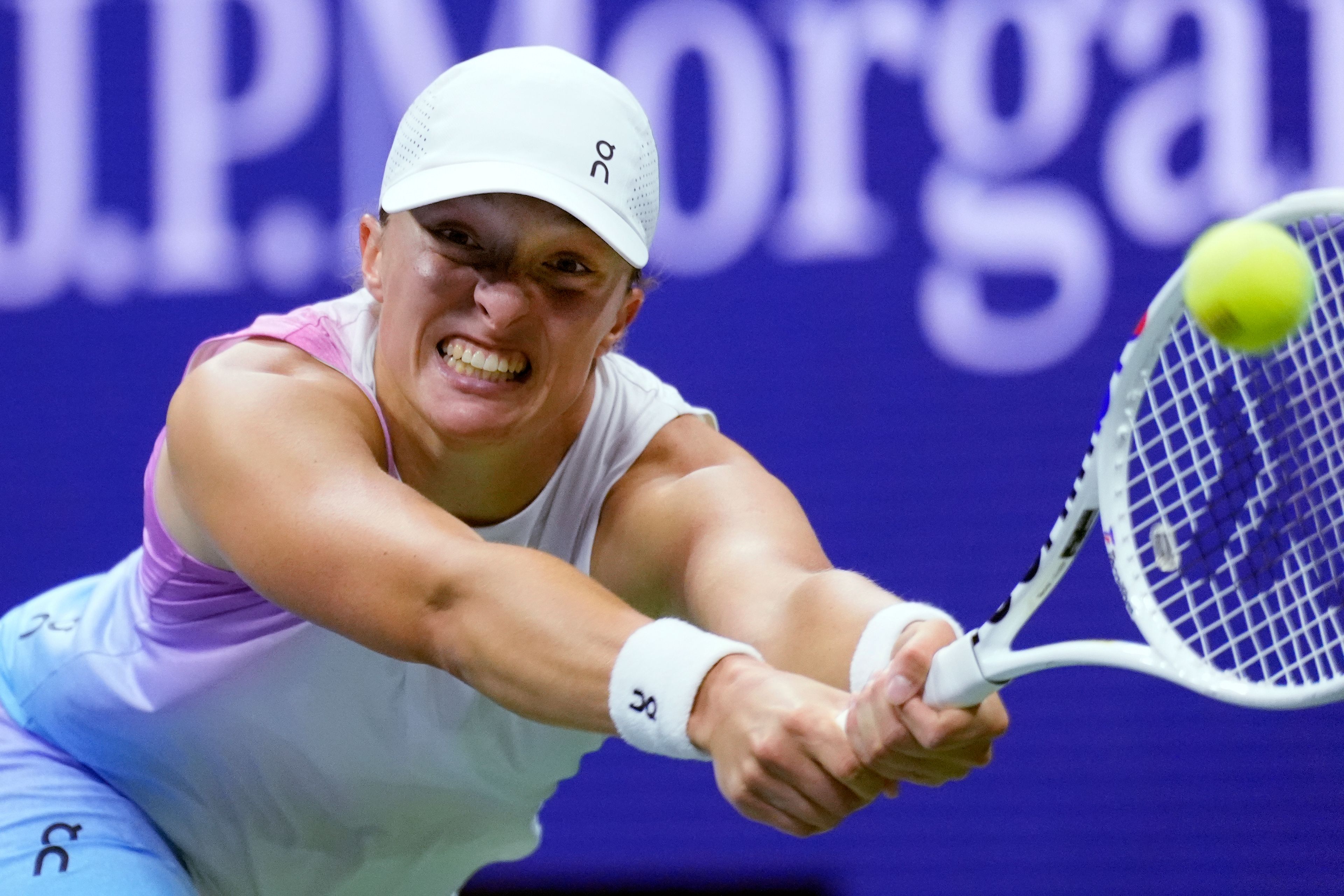 Iga Swiatek, of Poland, reaches out to hit a return to Jessica Pegula, of the United States, during the quarterfinals of the U.S. Open tennis tournament, Wednesday, Sept. 4, 2024, in New York.