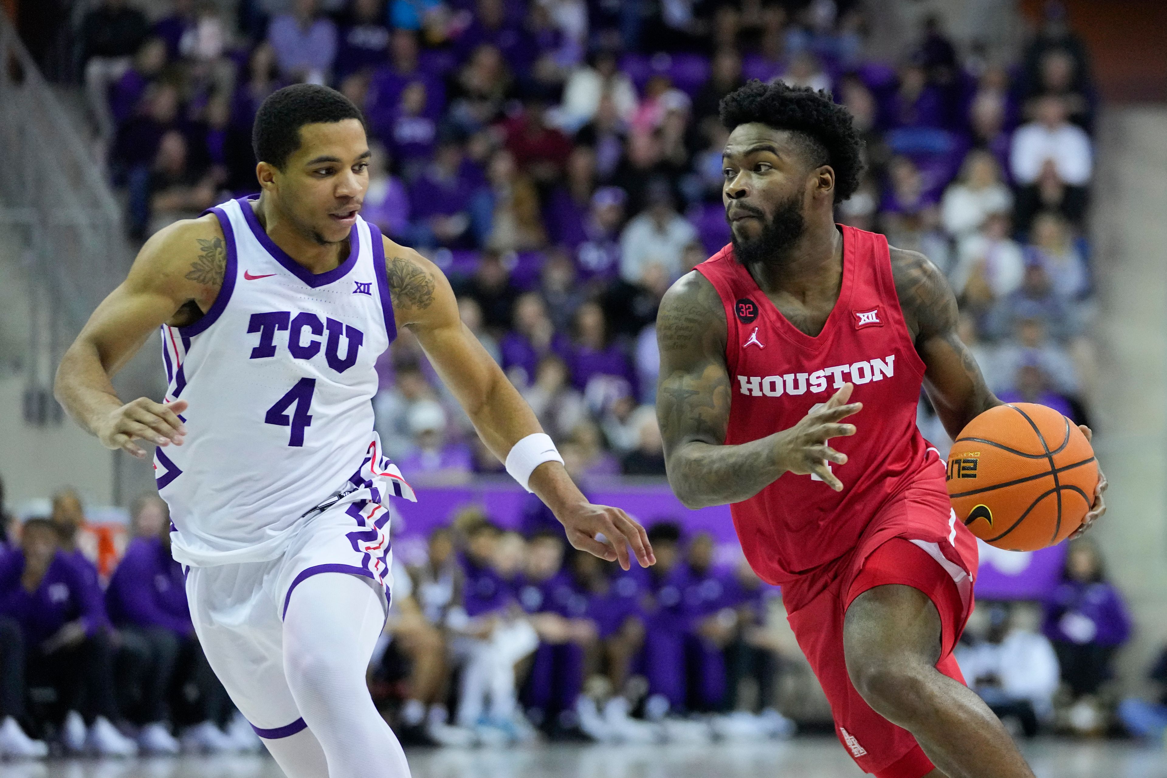 Houston guard Jamal Shead, right, drives against TCU guard Jameer Nelson Jr. during the second half of an NCAA college basketball game, Saturday, Jan. 13, 2024, in Fort Worth, Texas. TCU won 68-67. (AP Photo/Julio Cortez)