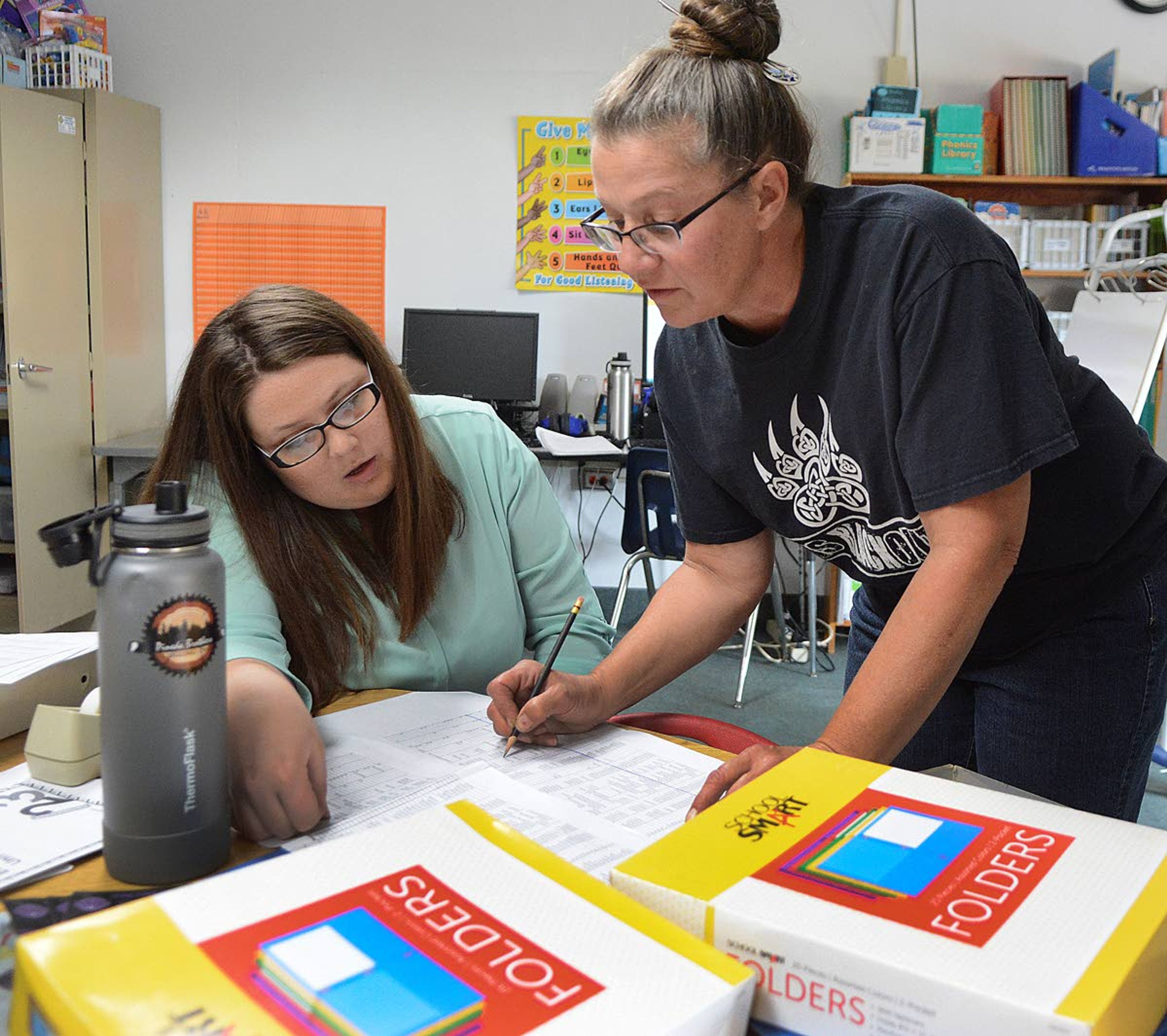 Special education teacher Cheryl Morris (right) and teacher’s aide Nicole Weeks work on the schedule for their 34 students in kindergarden through sixth grade.