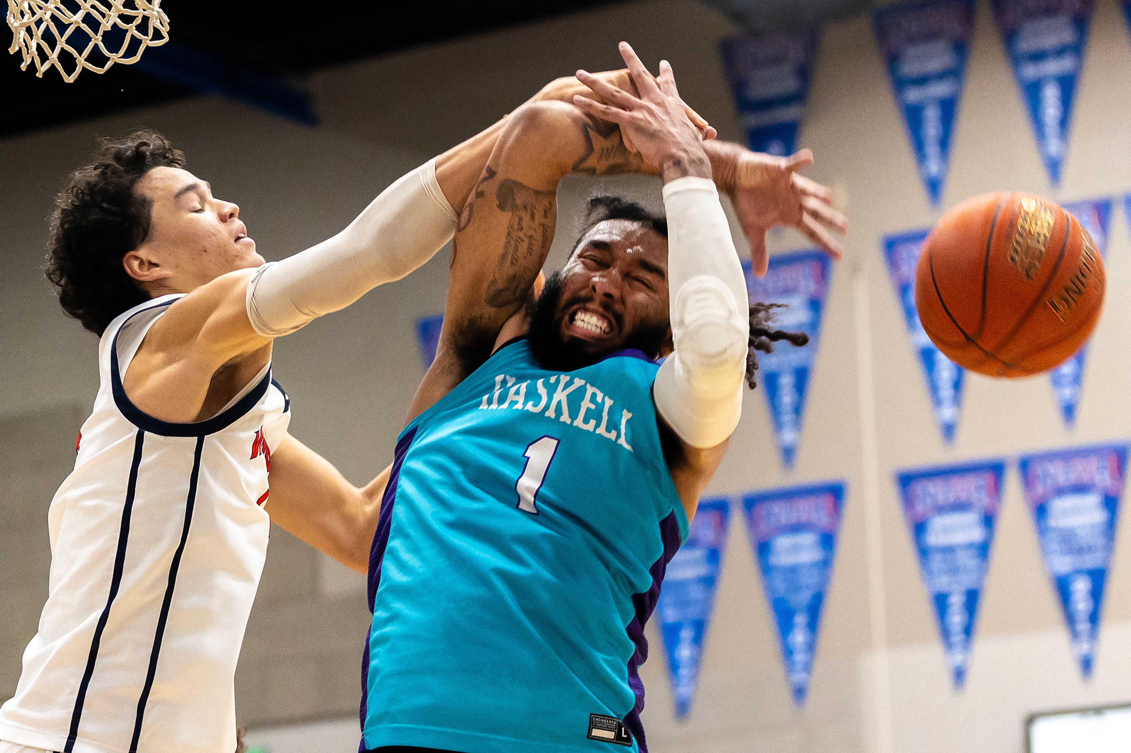 Lewis-Clark State forward Alton Hamilton knocks the ball away from Haskell�s DK Middleton during the season opening game as part of Tribal Nations Weekend Saturday in Lewiston.,