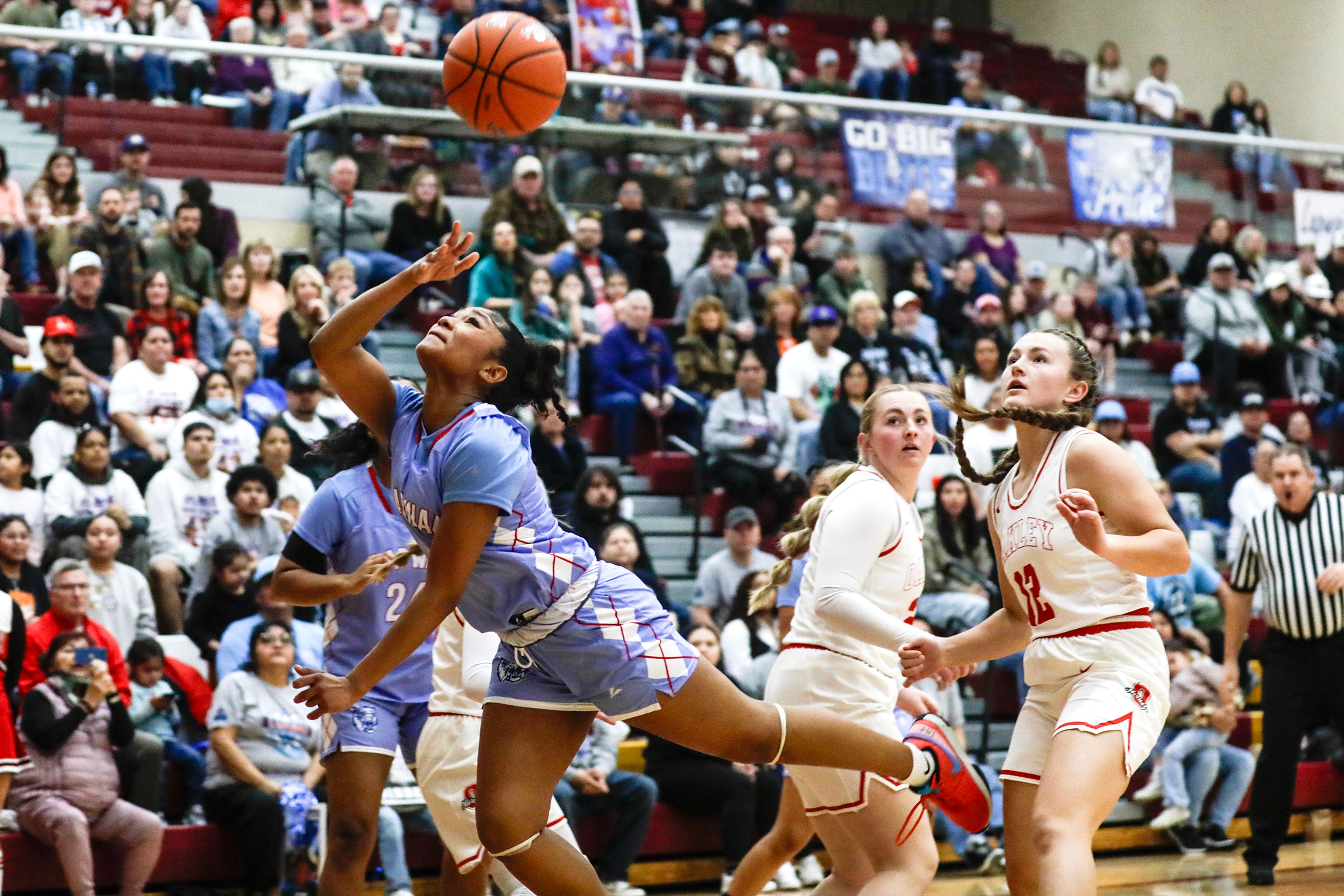 Lapwai's Samara Powaukee throws the ball toward the basket as she prepares to hit the ground against Oakley during an Idaho Class 1A DI girls state semifinal game Friday at Columbia High School.