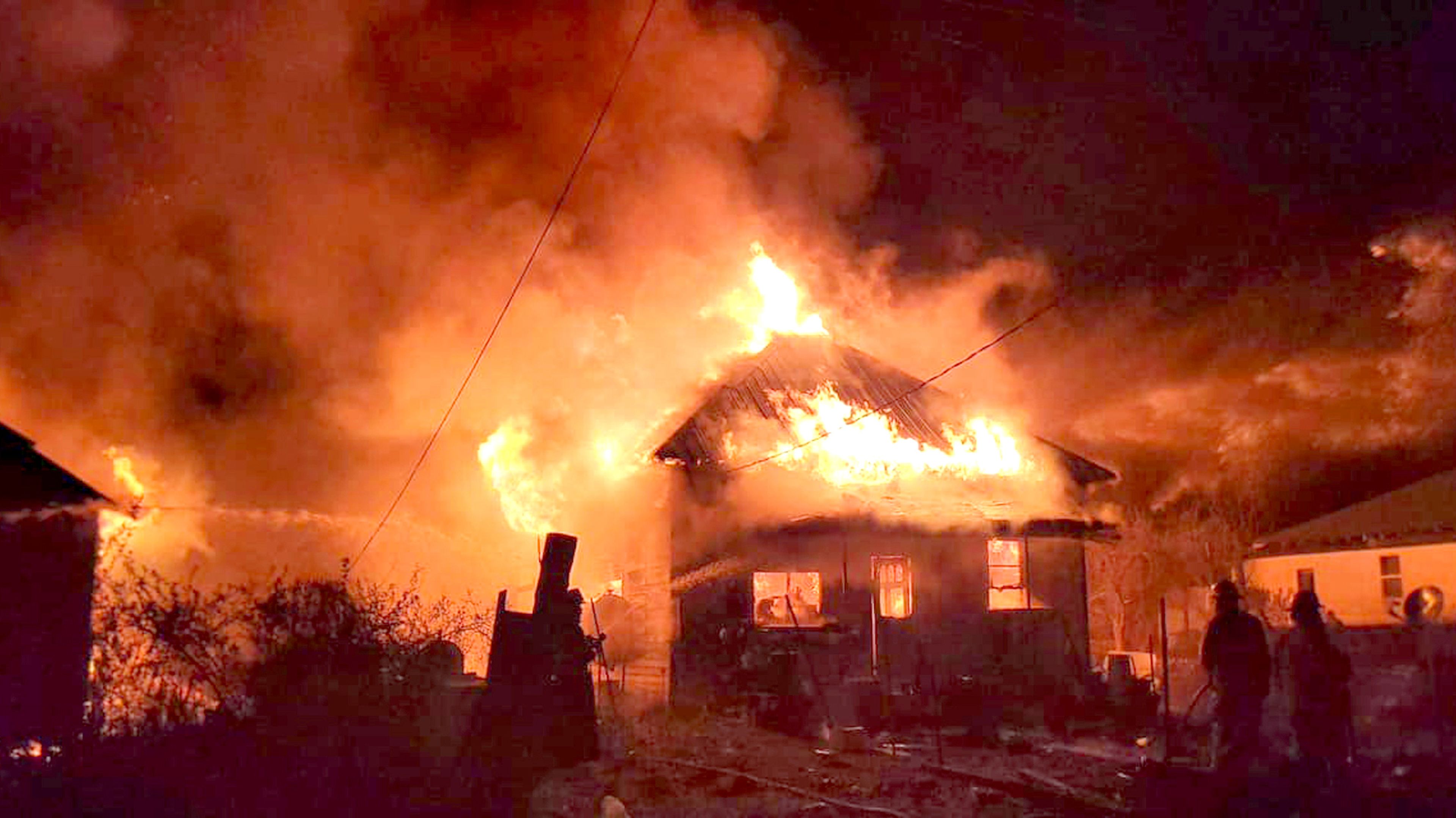 A house burns along Fall Avenue in Kooskia on Sunday night. Three residences were among the structures destroyed in the fire.