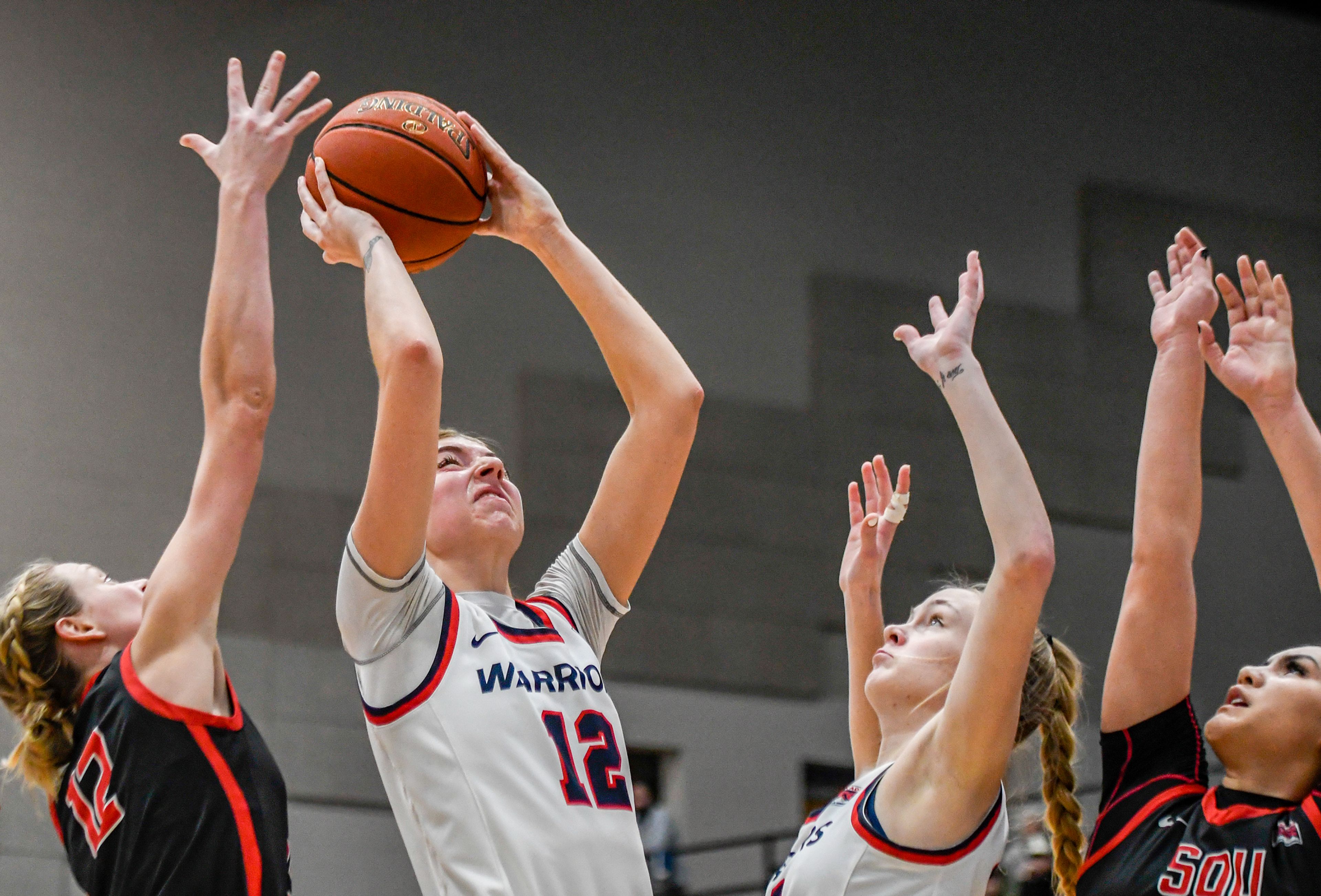 Lewis-Clark State post Sara Muehlhausen, second from left, shoots during Saturday's Cascade Conference game against Southern Oregon at the P1FCU Activity Center.