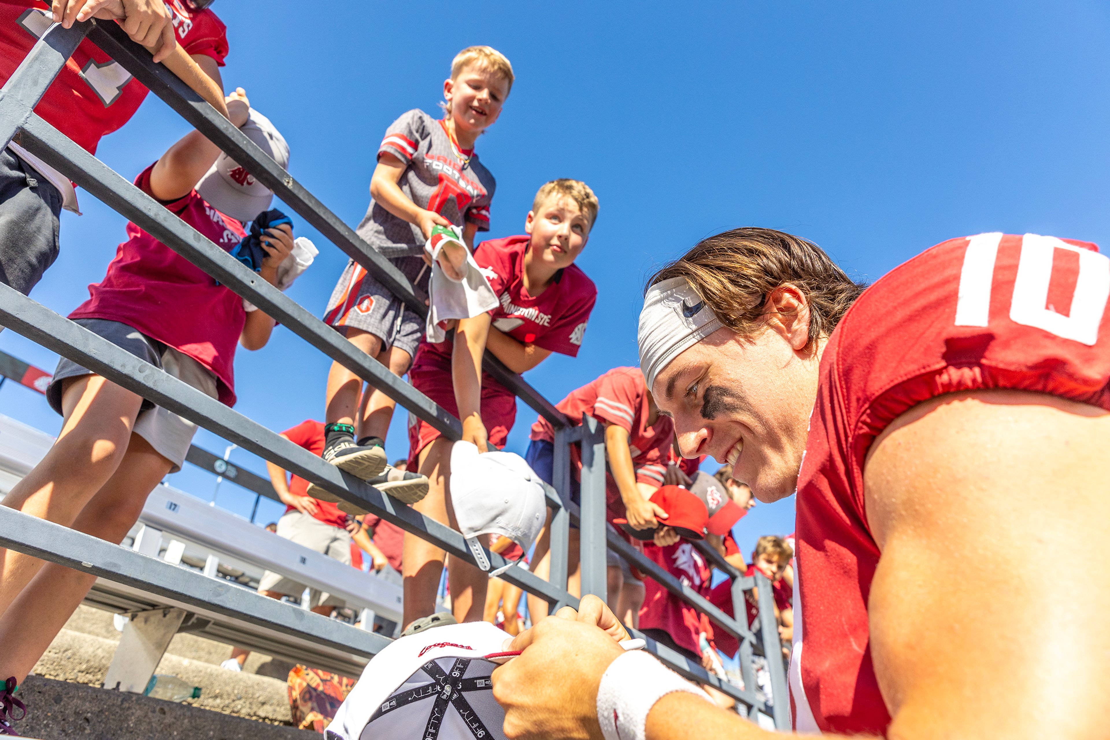 Washington State quarterback John Mateer signs autographs for young fans following their victory over Portland State during a quarter of a nonconference game at Gesa Field in Pullman.