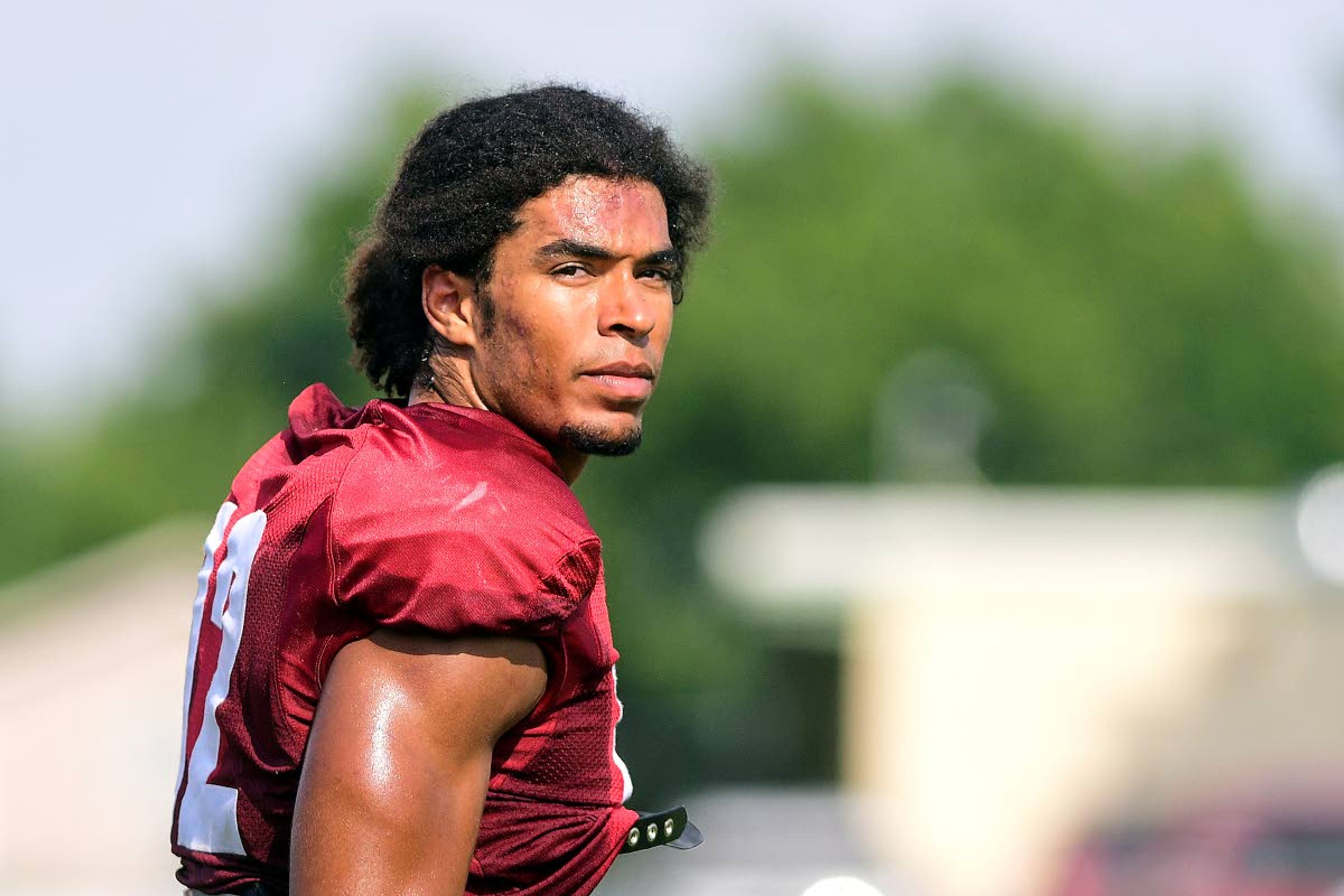 Washington State receiver Dezmon Patmon walks toward a huddle in between drills on Tuesday in Lewiston.