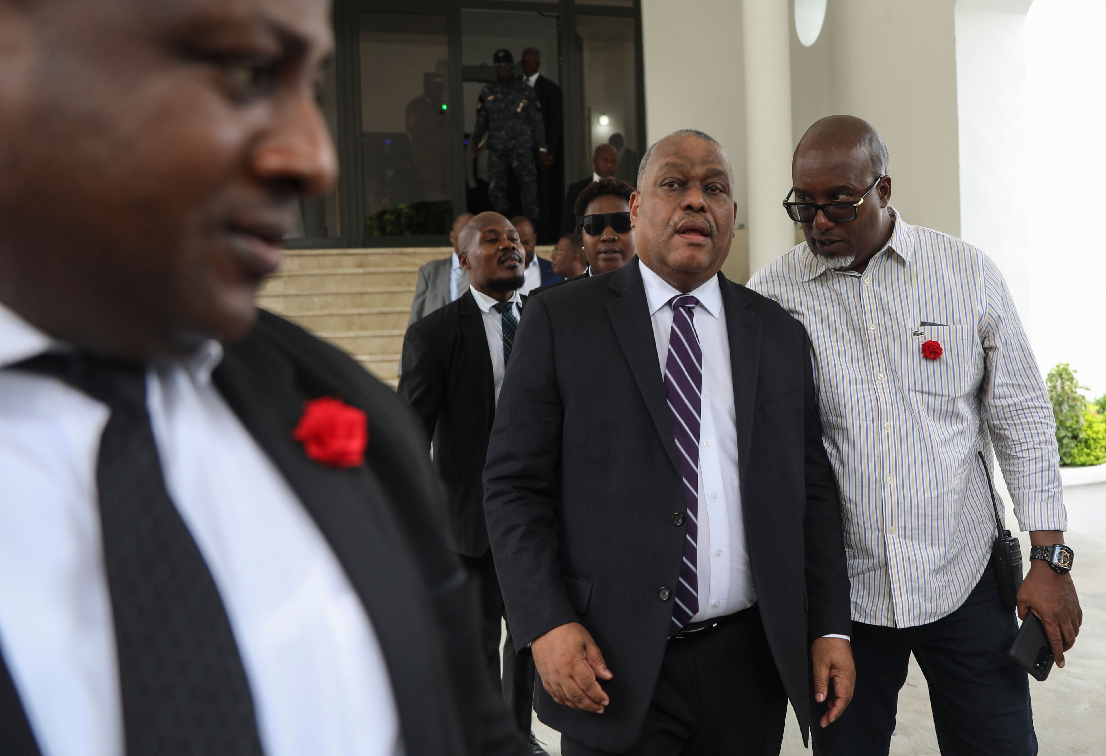 Garry Conille, center, leaves his swearing-in ceremony as prime minister in Port-au-Prince, Haiti, Monday, June 3, 2024.