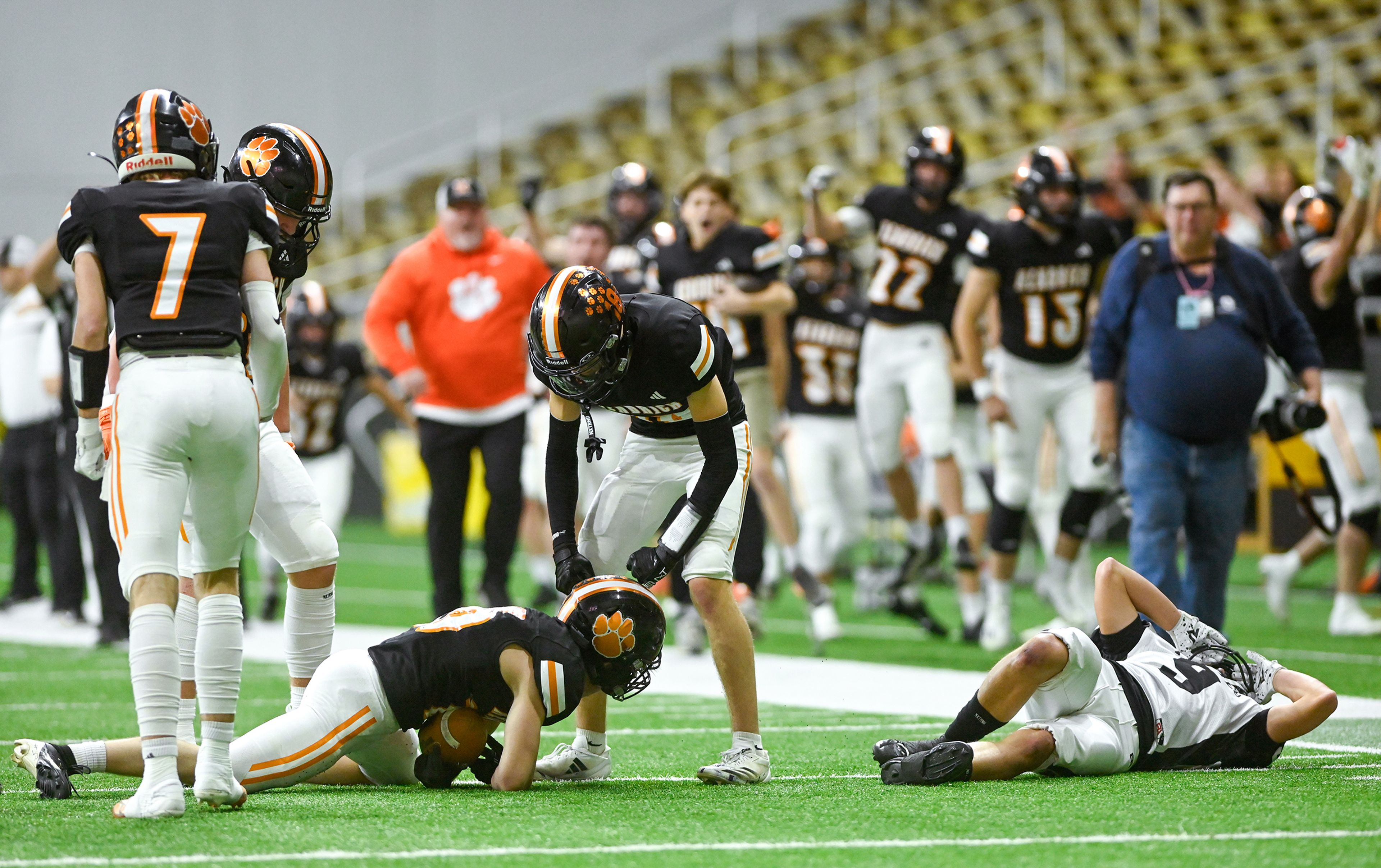 Kendrick players celebrate from the sidelines after Kendrick’s Orion Stewart regained possession of the ball after a kickoff to Butte County Friday during the Idaho 2A football state championship game at the P1FCU Kibbie Dome in Moscow.