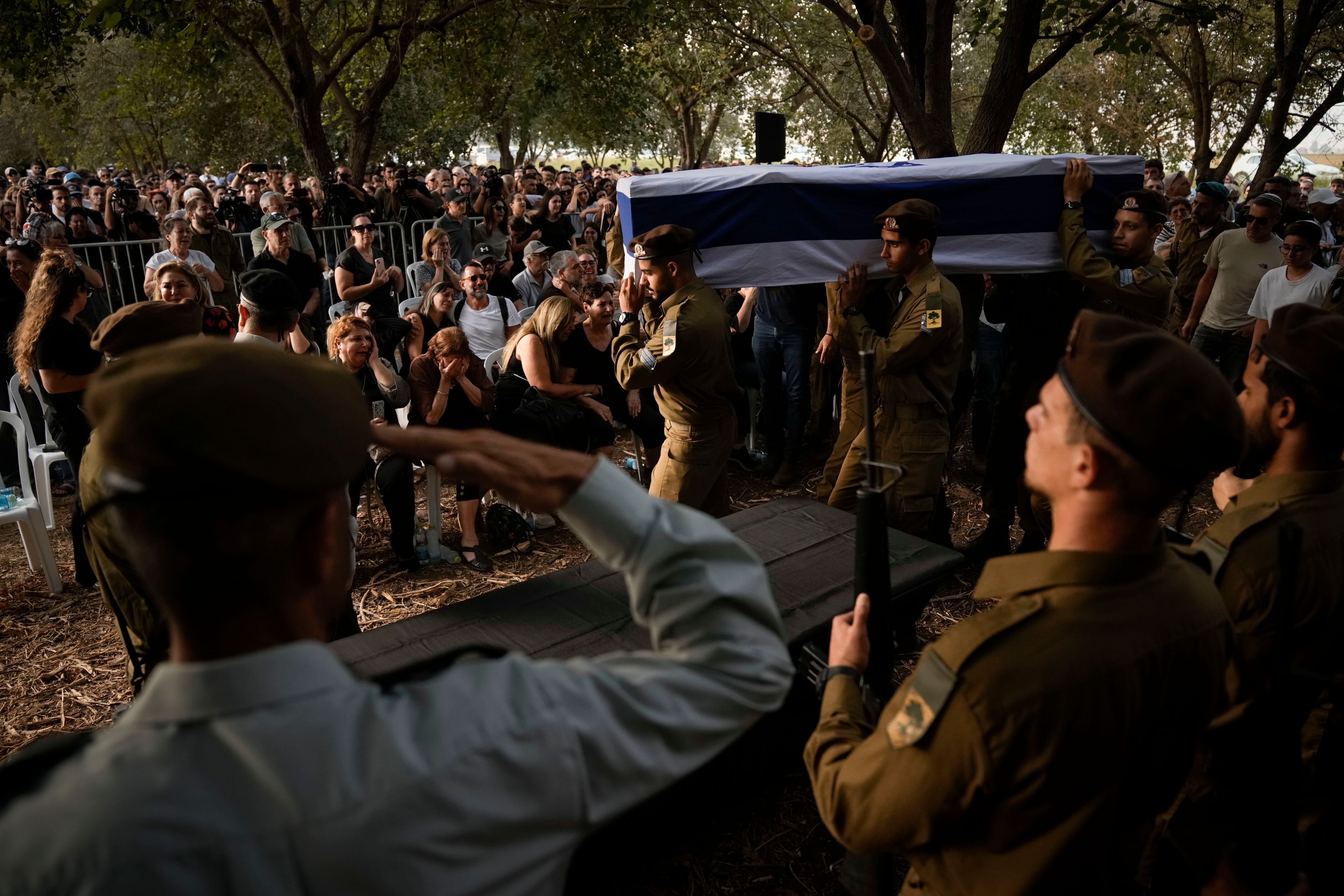 Israeli soldiers carry the flagged-covered coffin of Sgt. Amitai Alon, killed by a Hezbollah drone attack, during his funeral near Ramot Naftali, Israel, Monday, Oct. 14, 2024. (AP Photo/Leo Correa)