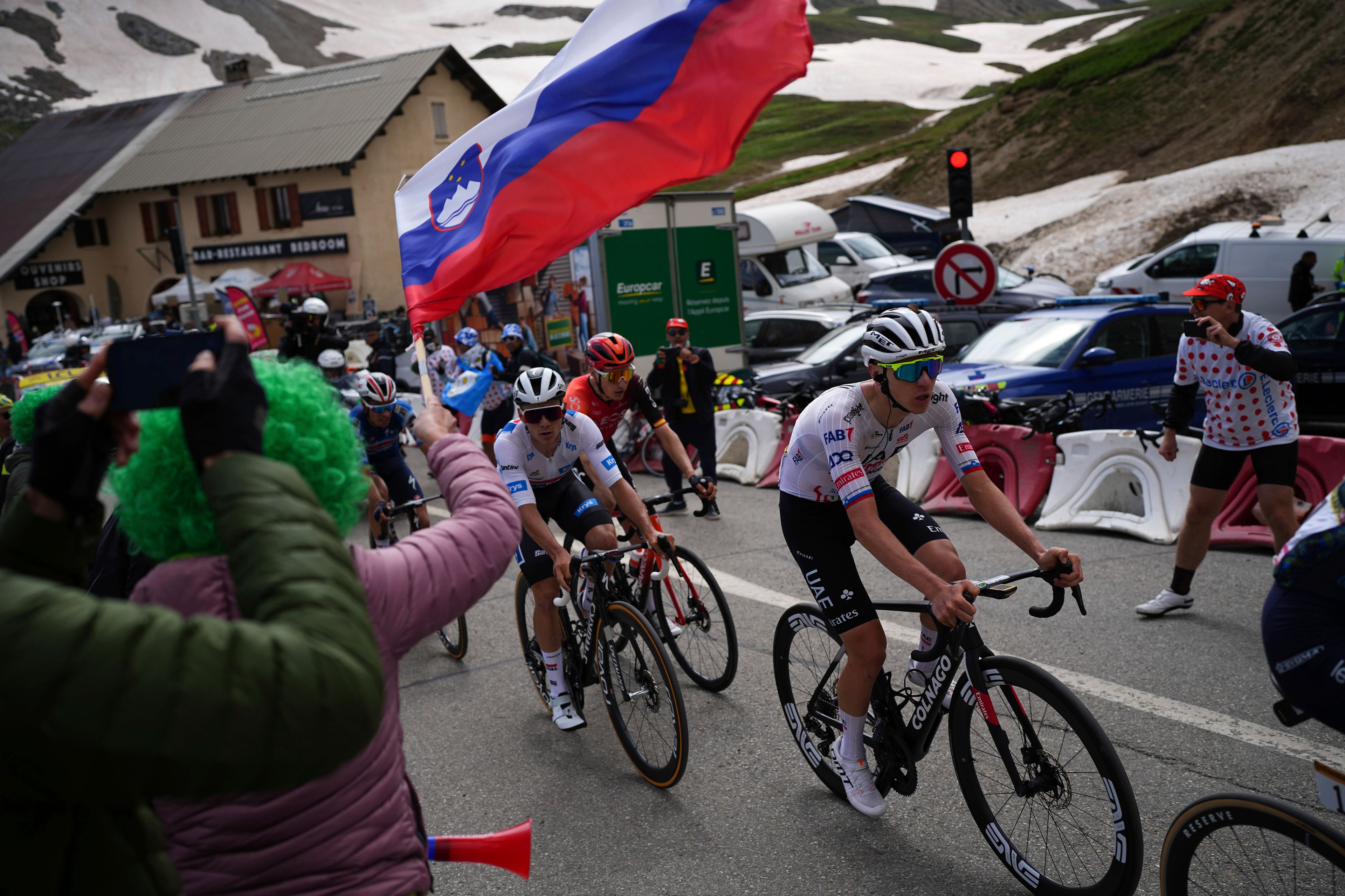 Slovenia's Tadej Pogacar, right, rides to climb the Col du Galibier during the fourth stage of the Tour de France cycling race over 139.6 kilometers (86.7 miles) with start in Pinerolo, Italy and finish in Valloire, France, Tuesday, July 2, 2024. (AP Photo/Daniel Cole)