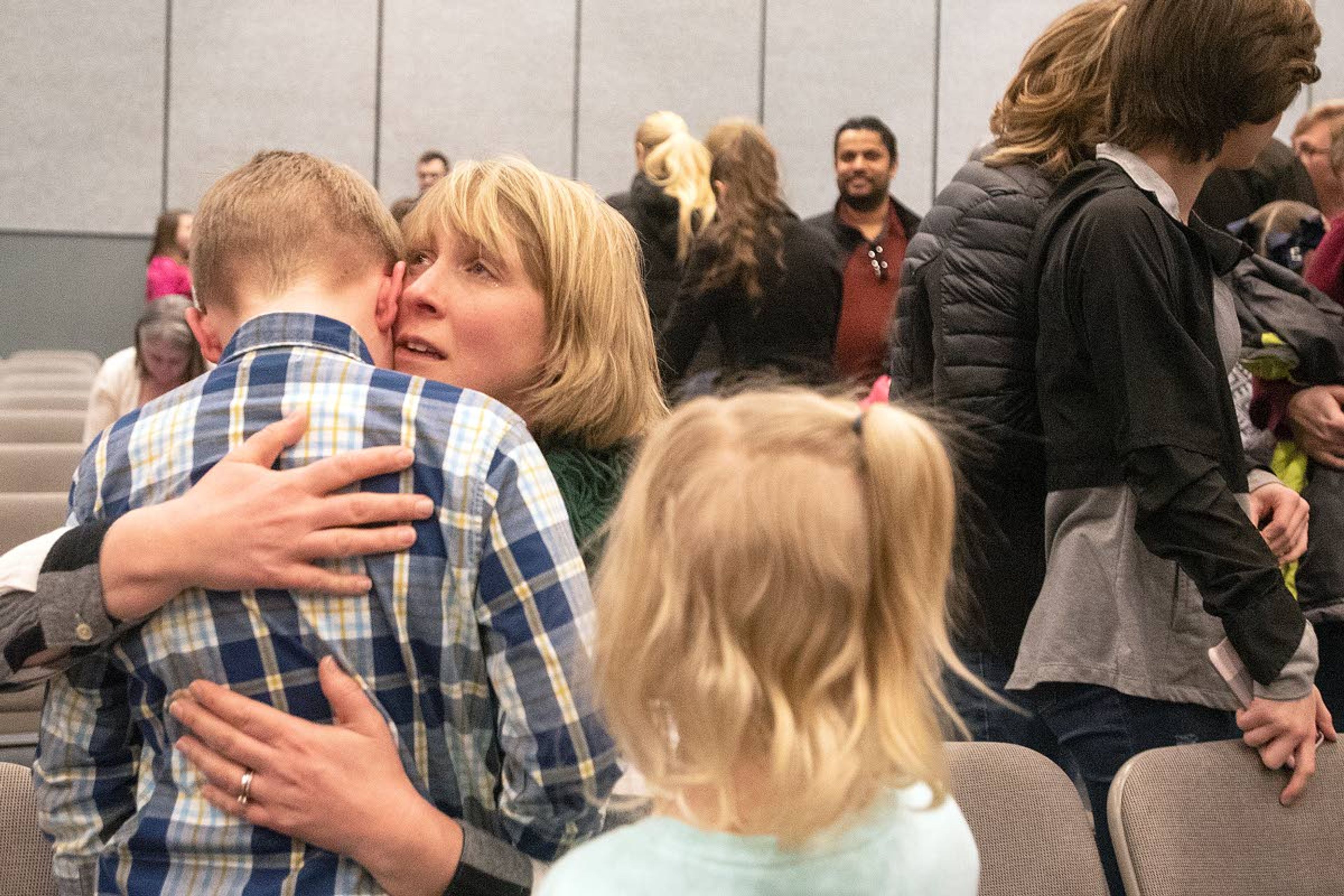 Blake Dobbins, a fifth grader from Sunnyside Elementary in Pullman, is comforted by a family member after the end of the 34th Annual Inland Northwest Regional Spelling Bee on Saturday in Lewiston. Dobbins misspelled trajectory in one of the final rounds of the competition and ended in fourth place.