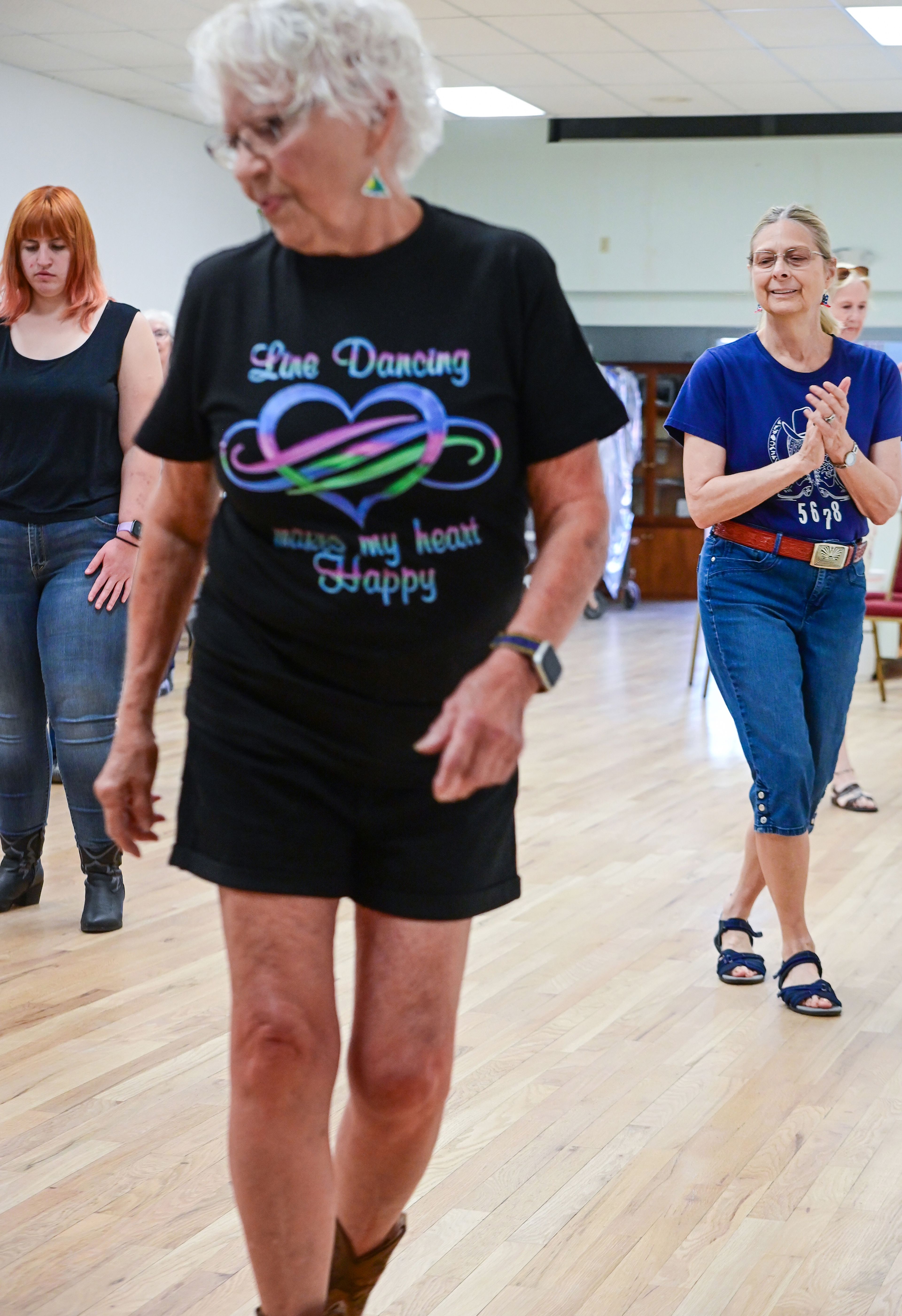 Pam Moore, right, watches the steps of those around her while leading a weekly line dance class at the Sixth Street Senior Center on Wednesday in Clarkston.