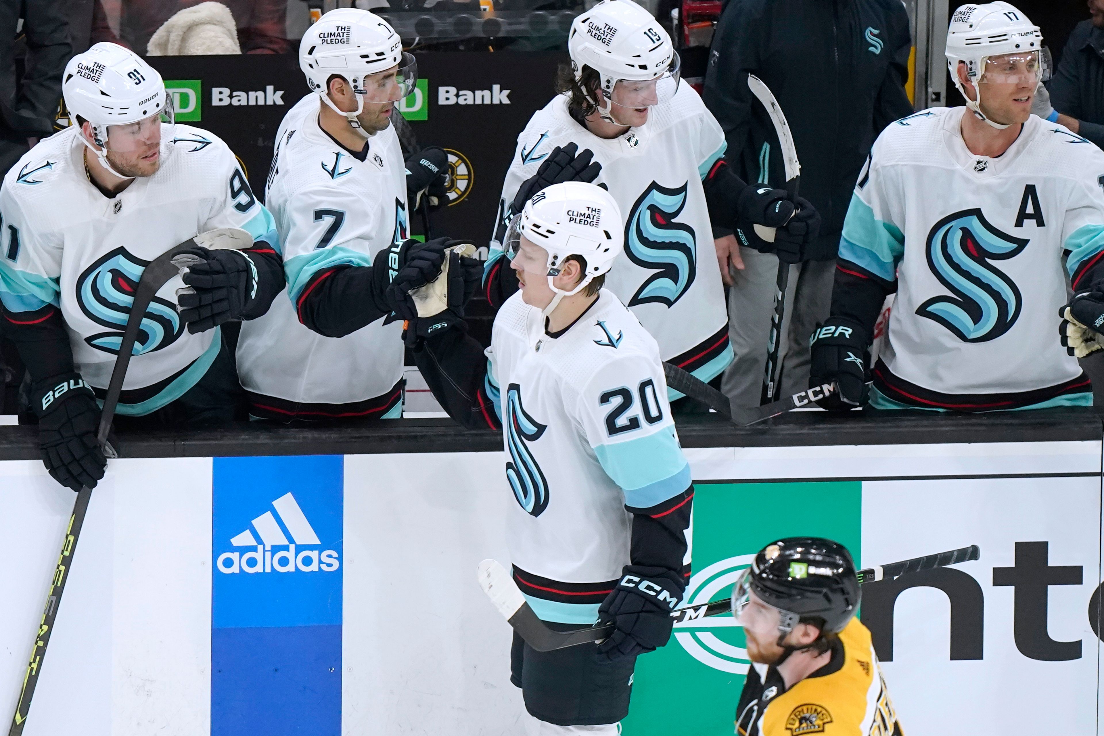 Seattle Kraken right wing Eeli Tolvanen (20) celebrates with teammates after scoring during the second period of the team's NHL hockey game against the Boston Bruins, Thursday, Jan. 12, 2023, in Boston. (AP Photo/Steven Senne)