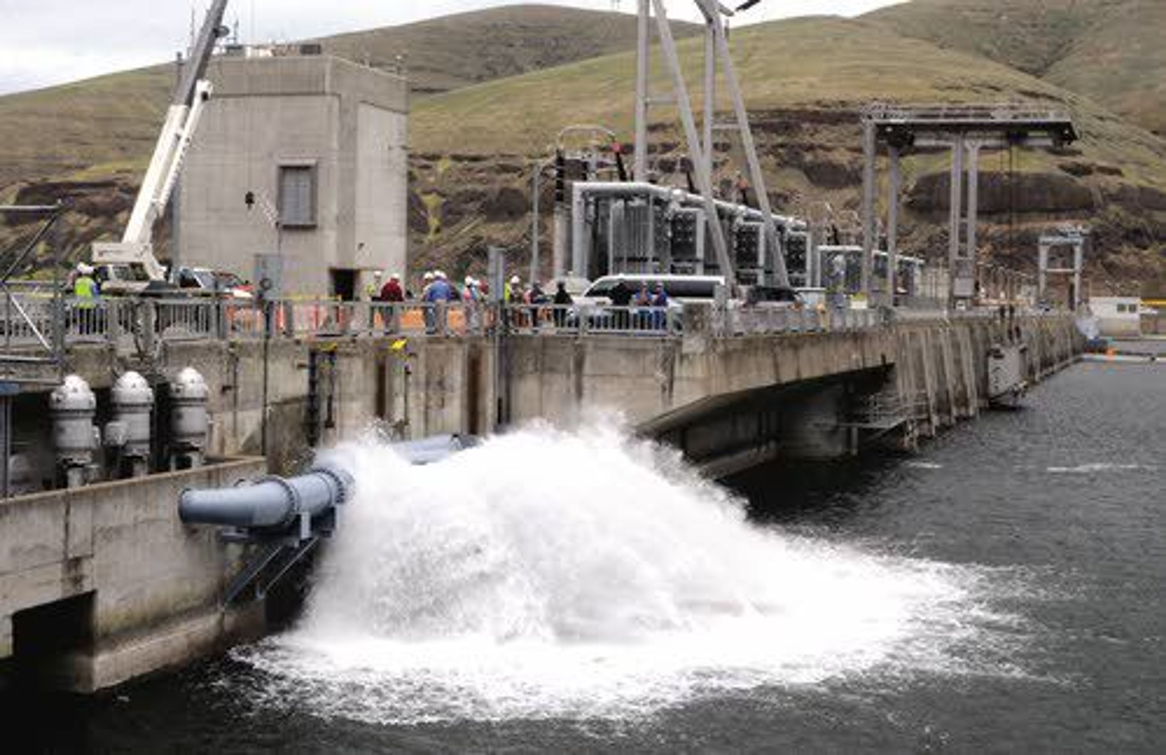 Cold water pumped from a depth of 70 feet sprays on the upstream side of Lower Granite Dam. A new analysis suggests a combination of wind and solar generation could replace power generated by the four lower Snake River dams within 10 years.