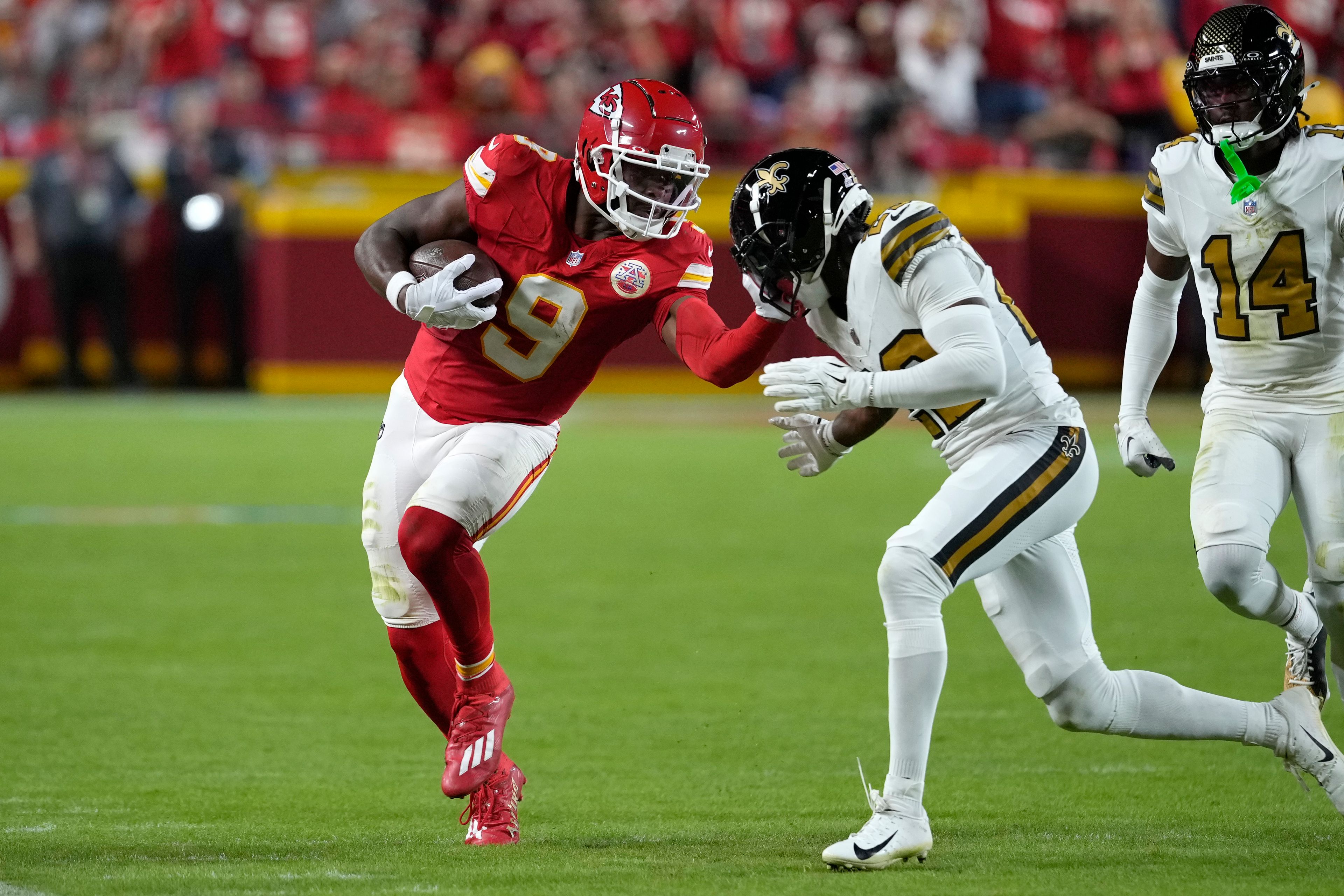 Kansas City Chiefs wide receiver JuJu Smith-Schuster (9) is forced out of bounds by New Orleans Saints cornerback Paulson Adebo after catching a pass during the first half of an NFL football game Monday, Oct. 7, 2024, in Kansas City, Mo. (AP Photo/Ed Zurga)