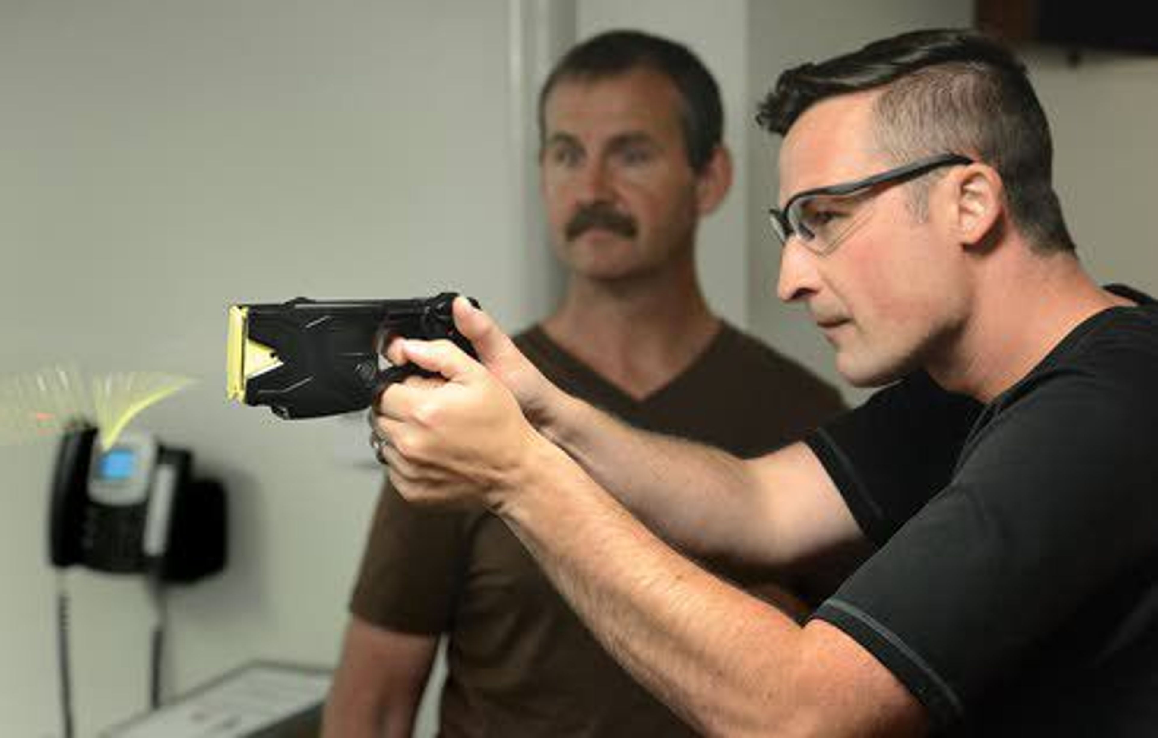 Lewiston Police Department patrol officer Tyler Crane tests out his new Taser during training with LPD Taser instructor Mike Rigney at police headquarters.