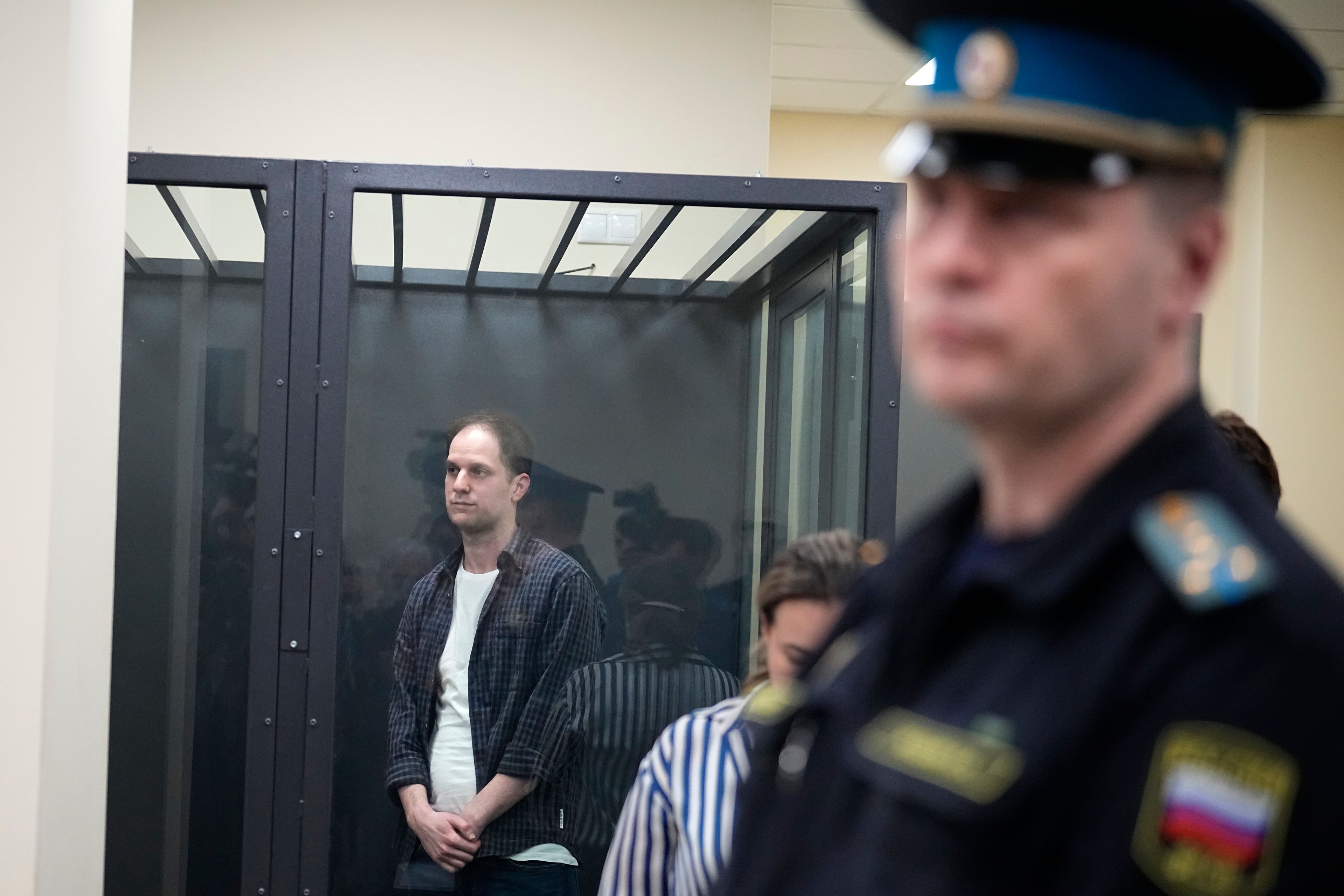 FILE - Wall Street Journal reporter Evan Gershkovich, left, stands in a glass cage in a courtroom at the First Appeals Court of General Jurisdiction in Moscow, Russia, Tuesday, April 23, 2024. Arrests on charges of spying and collecting sensitive data have become increasingly frequent in Russia since it sent troops into Ukraine in February 2022. Recent high-profile arrests include Wall Street Journal reporter Evan Gershkovich, who was arrested on espionage charges in March 2023.