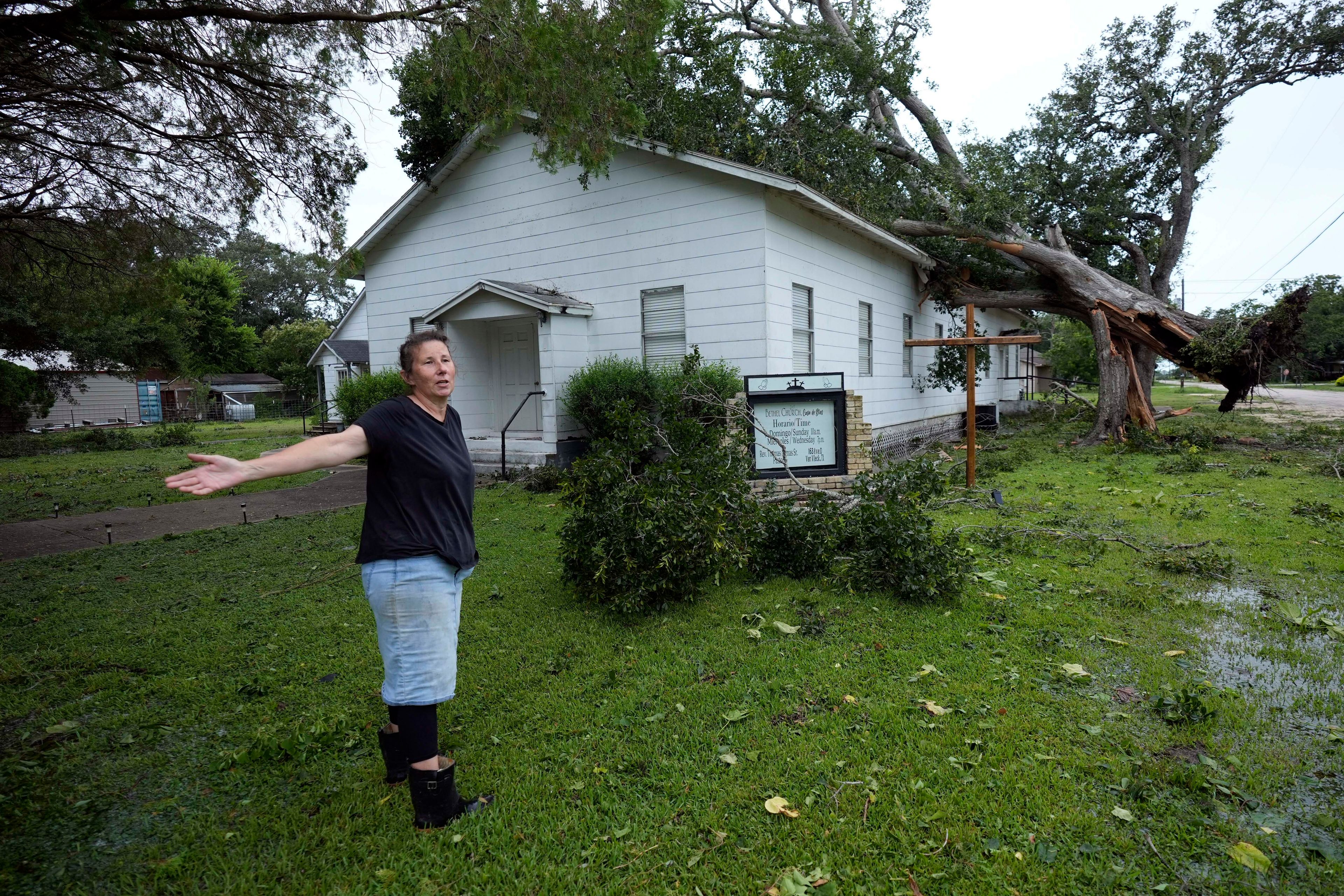 Ann McCauley examines the damage at Bethel Church after Hurricane Beryl moved through the area, Monday, July 8, 2024, in Van Vleck, Texas. (AP Photo/Eric Gay)