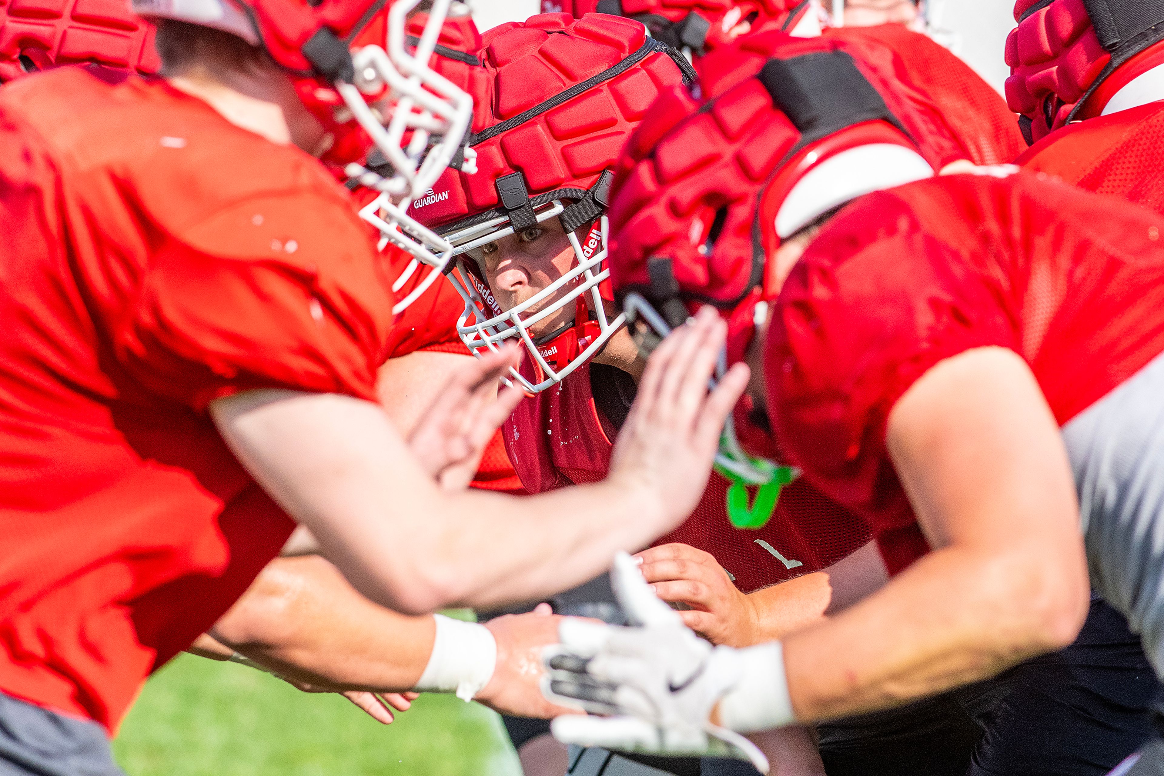 Clarkston defense runs off the line at football practice Tuesday in Clarkston.