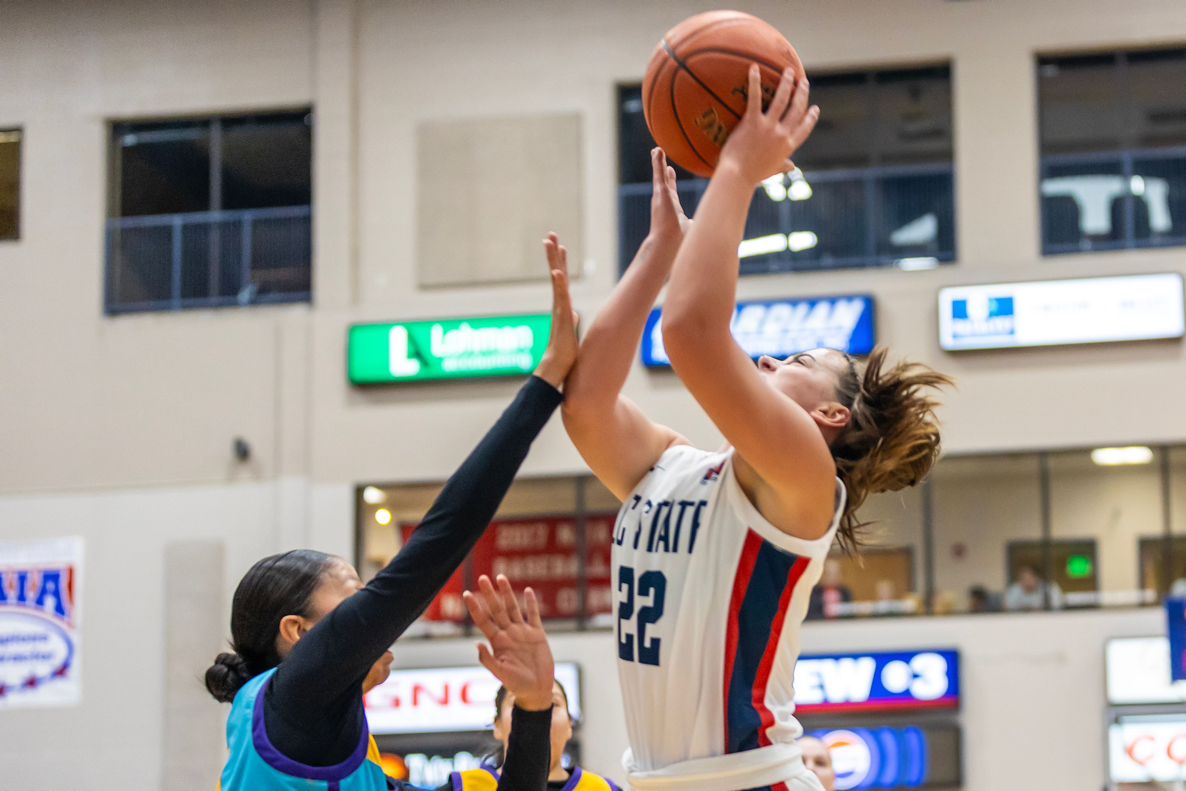 Lewis-Clark State guard Tessa Karlberg takes a shot over Haskell Star Her Many Horses during the season opening game as part of Tribal Nations Weekend Saturday in Lewiston.,