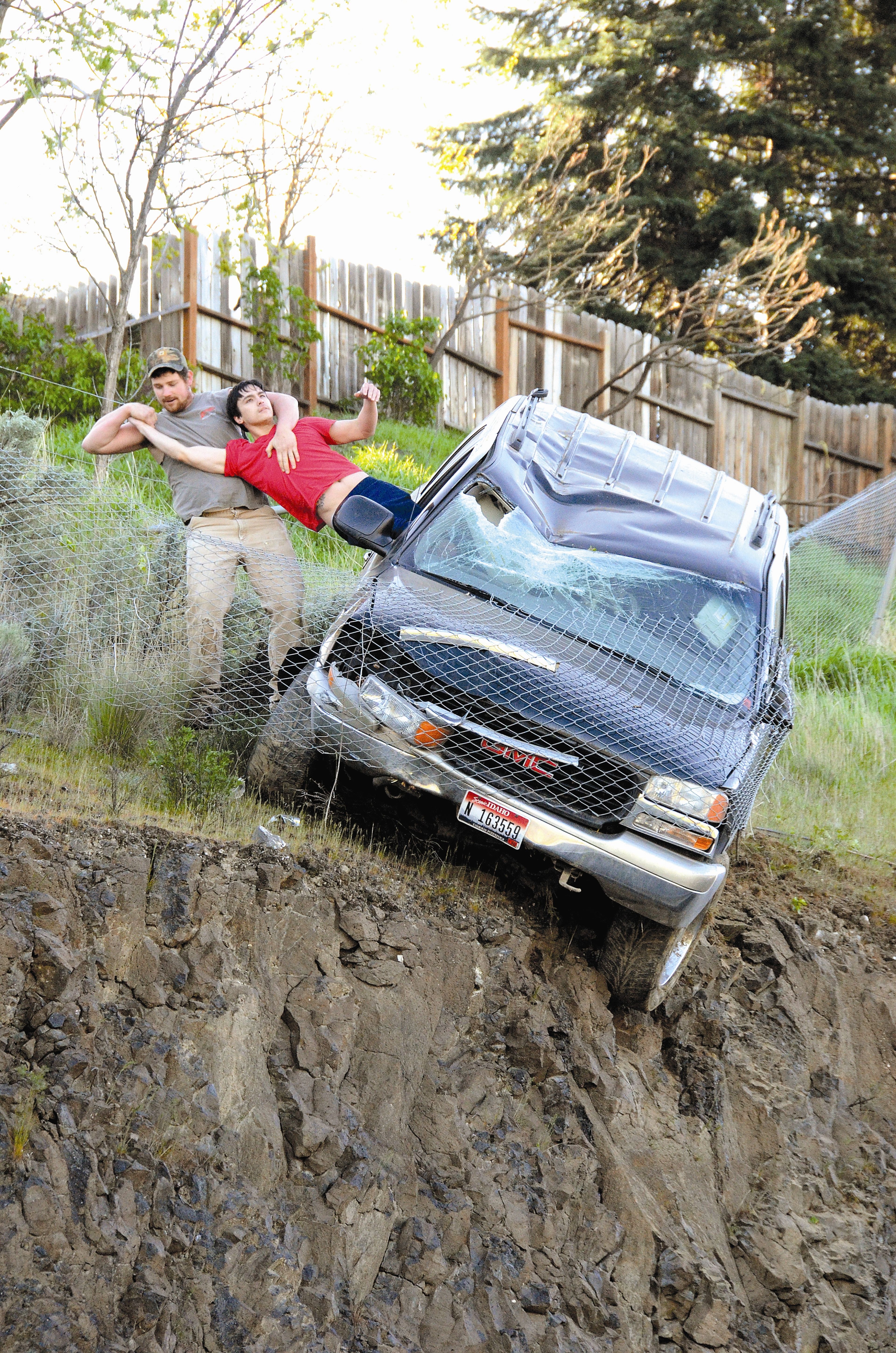 An unidentified passer-by pulls 23-year-old Mathew Sitko of Lewiston from an SUV this afternoon after smashing the window with a rock to rescue Sitko from the car. The vehicle left Mayfair Drive in Lewiston and traveled downhill before being stopped by a chain-link fence just short of a vertical drop onto Bryden Canyon Road. Stiko was taken to St. Joseph Regional Medical Center with minor injuries.