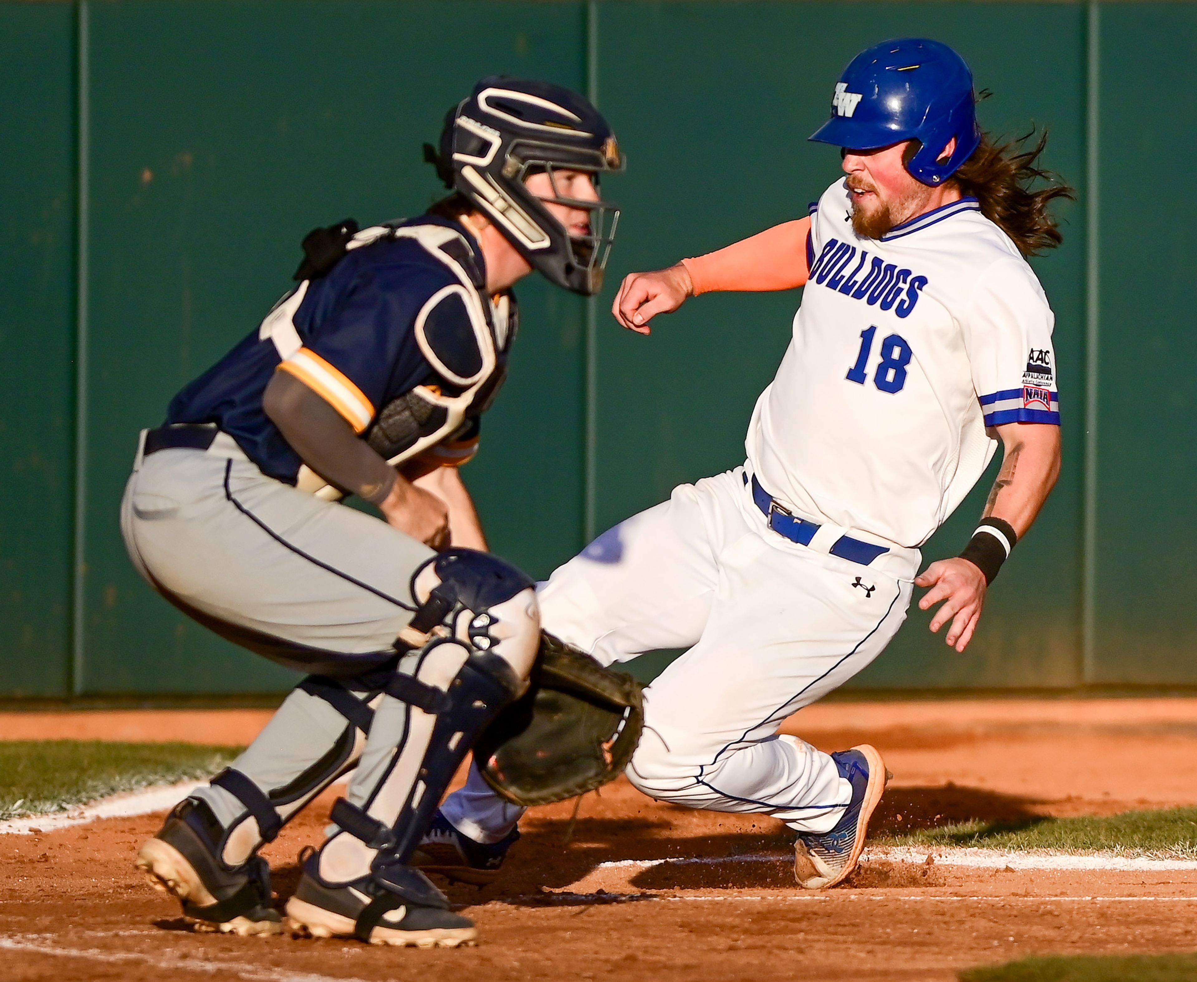 Tennessee Wesleyan’s Evan Magill slides into home plate in Game 18 of the NAIA World Series against Reinhardt at Harris Field in Lewiston on Thursday.