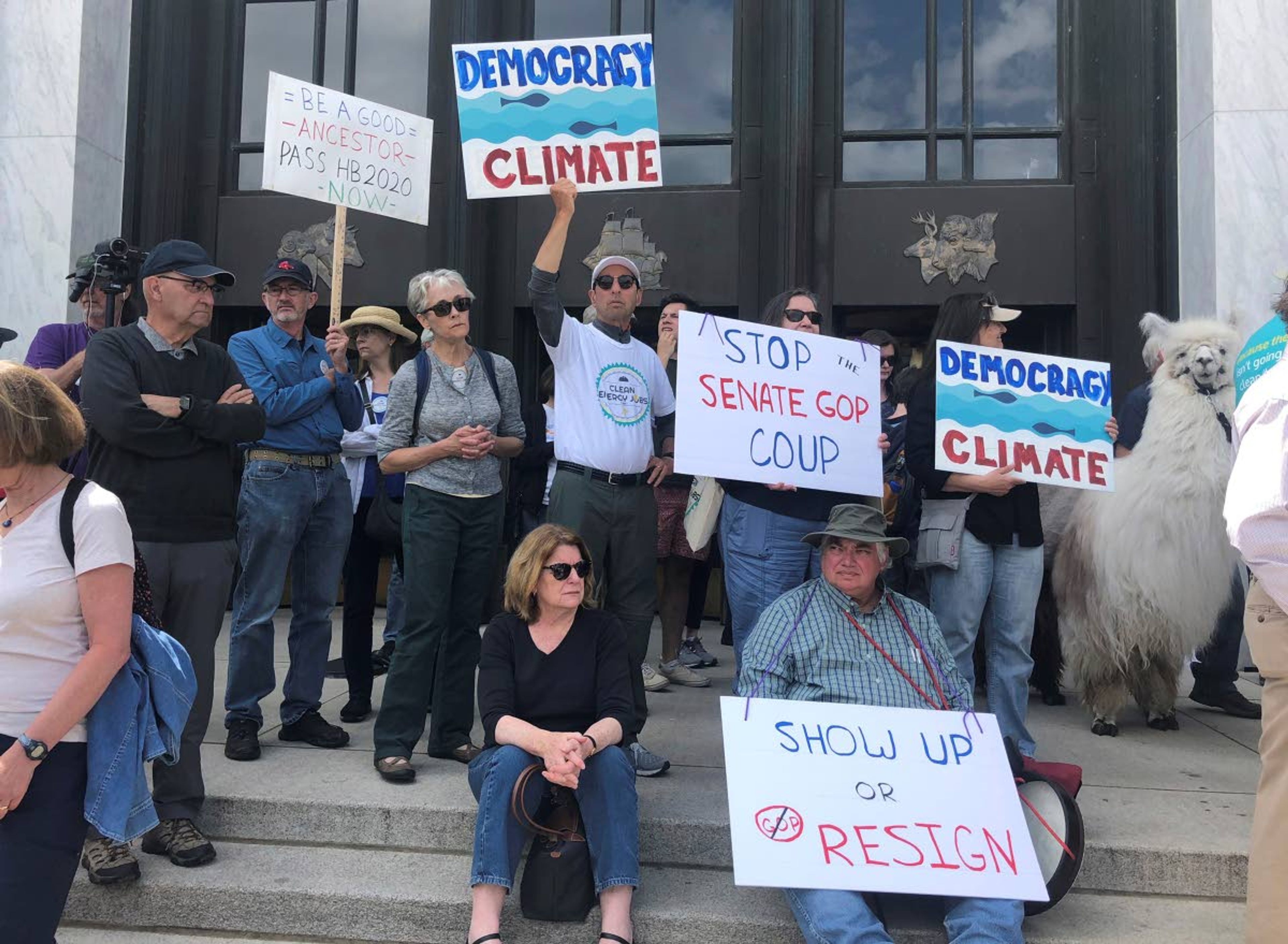 Protesters flood the steps of the Oregon State Capitol on Tuesday to push back against a Republican walkout over a climate change bill that has entered its sixth day in Salem, Ore.