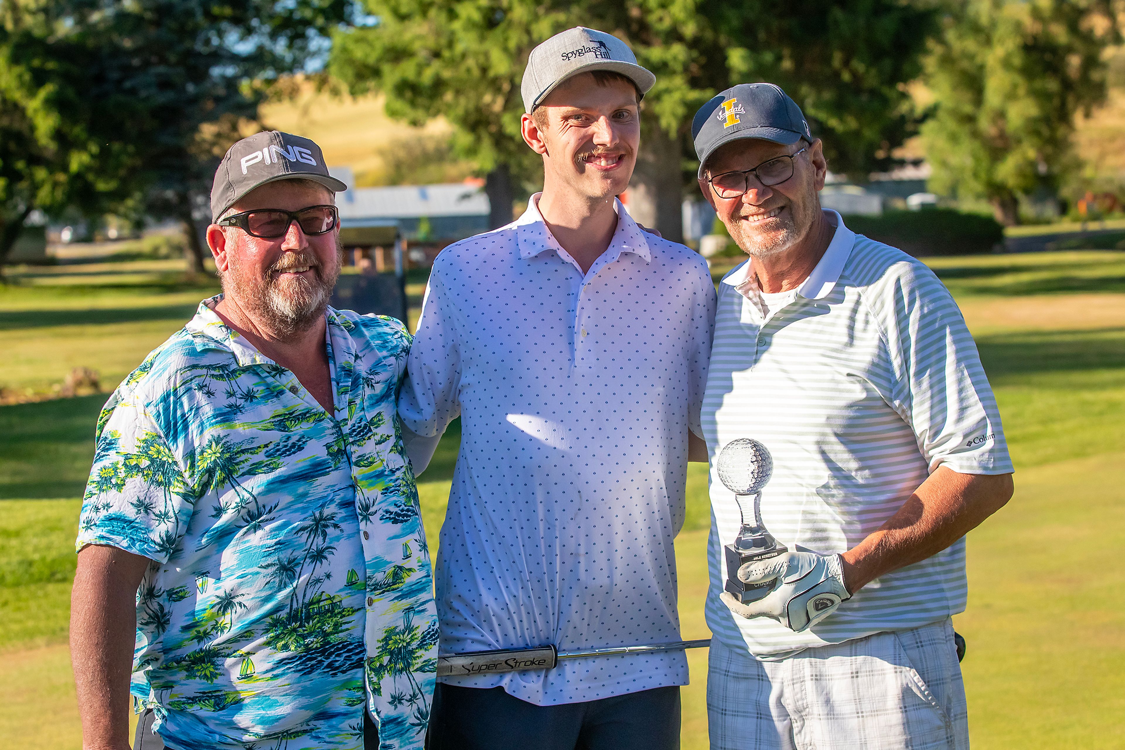 Kyle Nelson, right, poses for a photo with the trophy after winning the annual Moscow Elks Lodge Golf Club Sole Survivor tournament Thursday in Moscow.