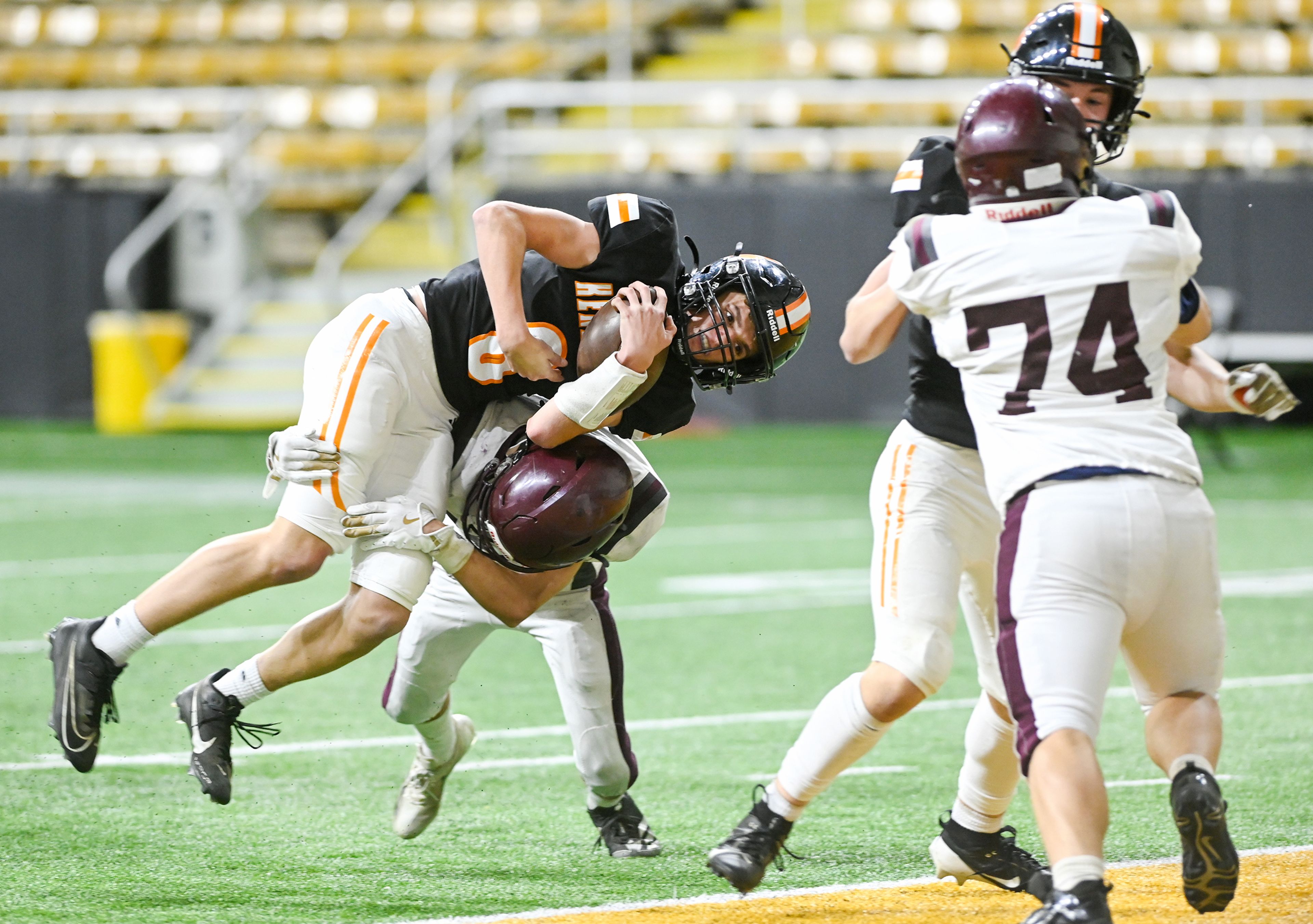 Kendrick’s Blake Morgan dives toward the end zone while being tackled by a Kamiah defender, landing Morgan in the end zone for a touchdown during an Idaho Class 2A state quarterfinal game at the P1FCU Kibbie Dome in Moscow.