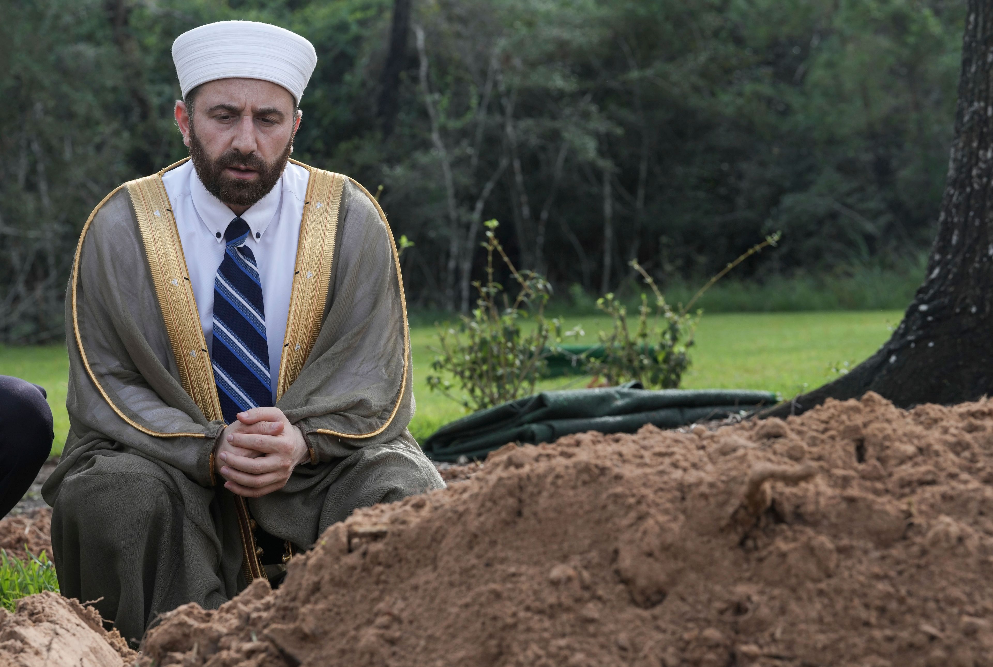 Imam Dr. Irhabi Mohamed Irhabi prays over the grave of slain Harris County Precinct 4 Deputy Constable Maher Husseini following his burial, Thursday, Sept. 5, 2024, at Forest Park The Woodlands Funeral Home & Cemetery in The Woodlands, Texas.