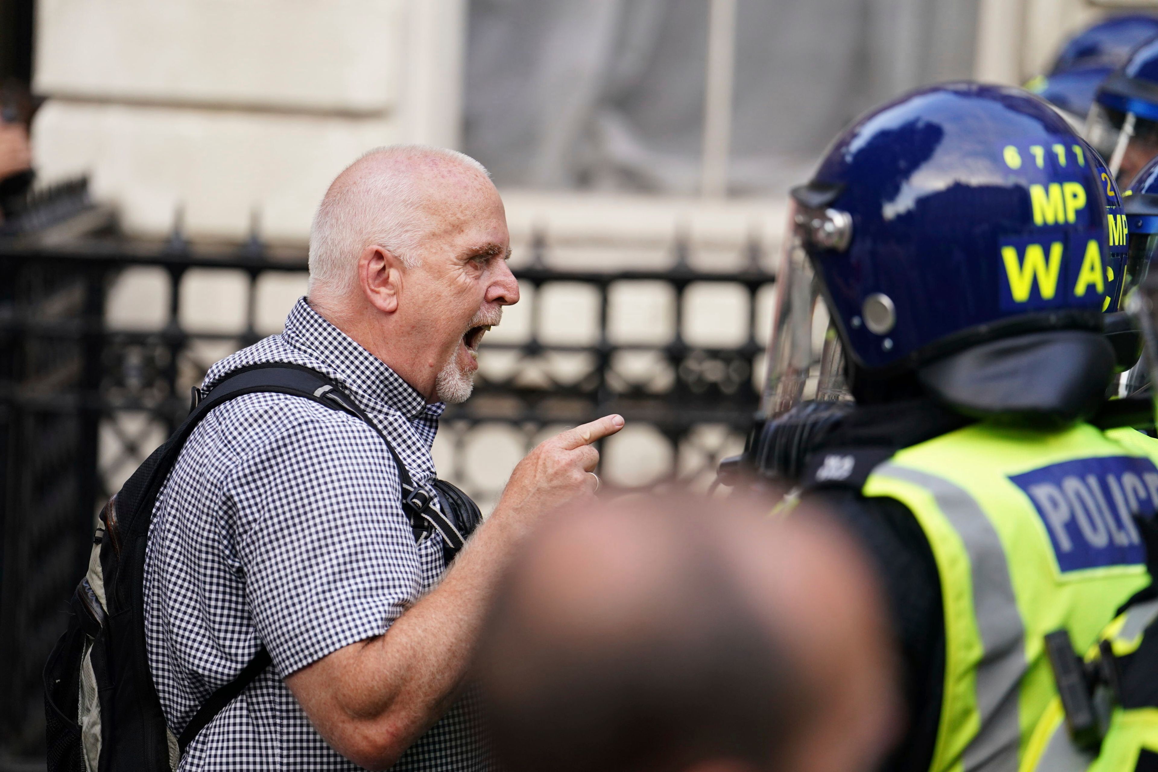 Protesters confront police officers during the "Enough is Enough" protest in Whitehall, London, Wednesday July 31, 2024, following the fatal stabbing of three children at a Taylor Swift-themed summer holiday dance and yoga class on Monday in Southport. (Jordan Pettitt/PA via AP)