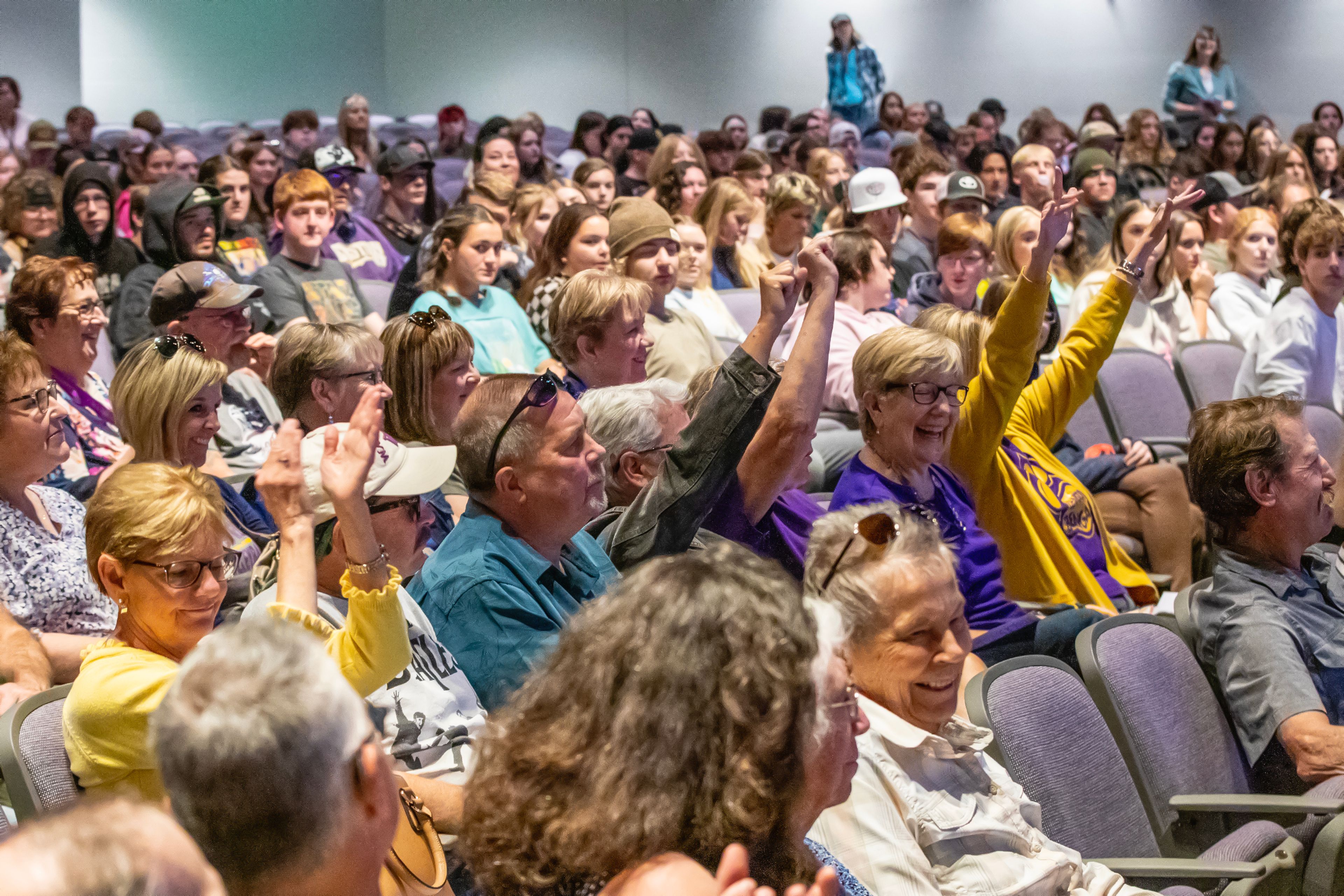 The Lewiston High School class of 1977 cheers as they are mentioned at the unveiling for the bengal statue on Thursday.