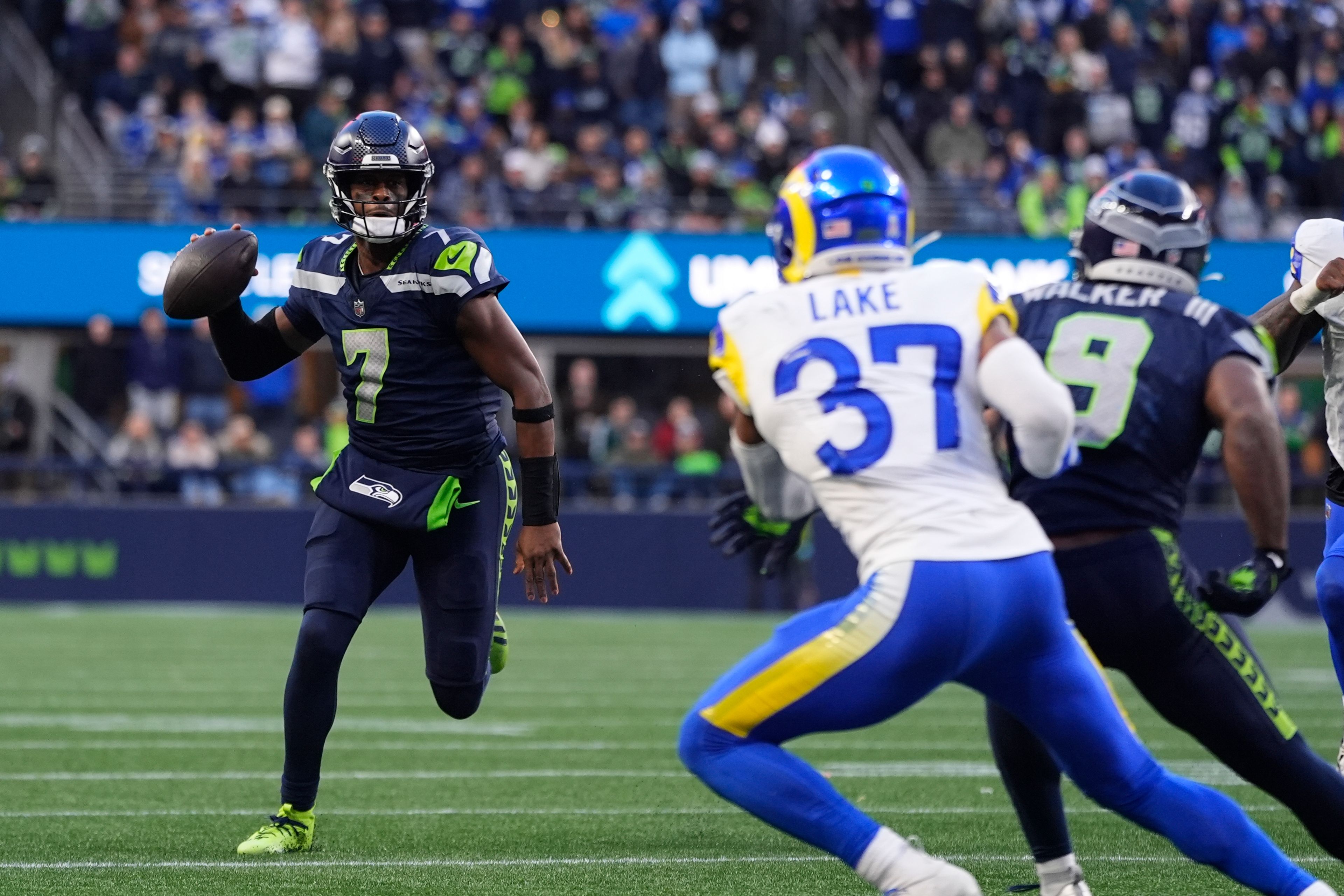 Seattle Seahawks quarterback Geno Smith runs with the ball against Los Angeles Rams safety Quentin Lake during an NFL football game, Sunday, Nov. 3, 2024, in Seattle. (AP Photo/Lindsey Wasson)