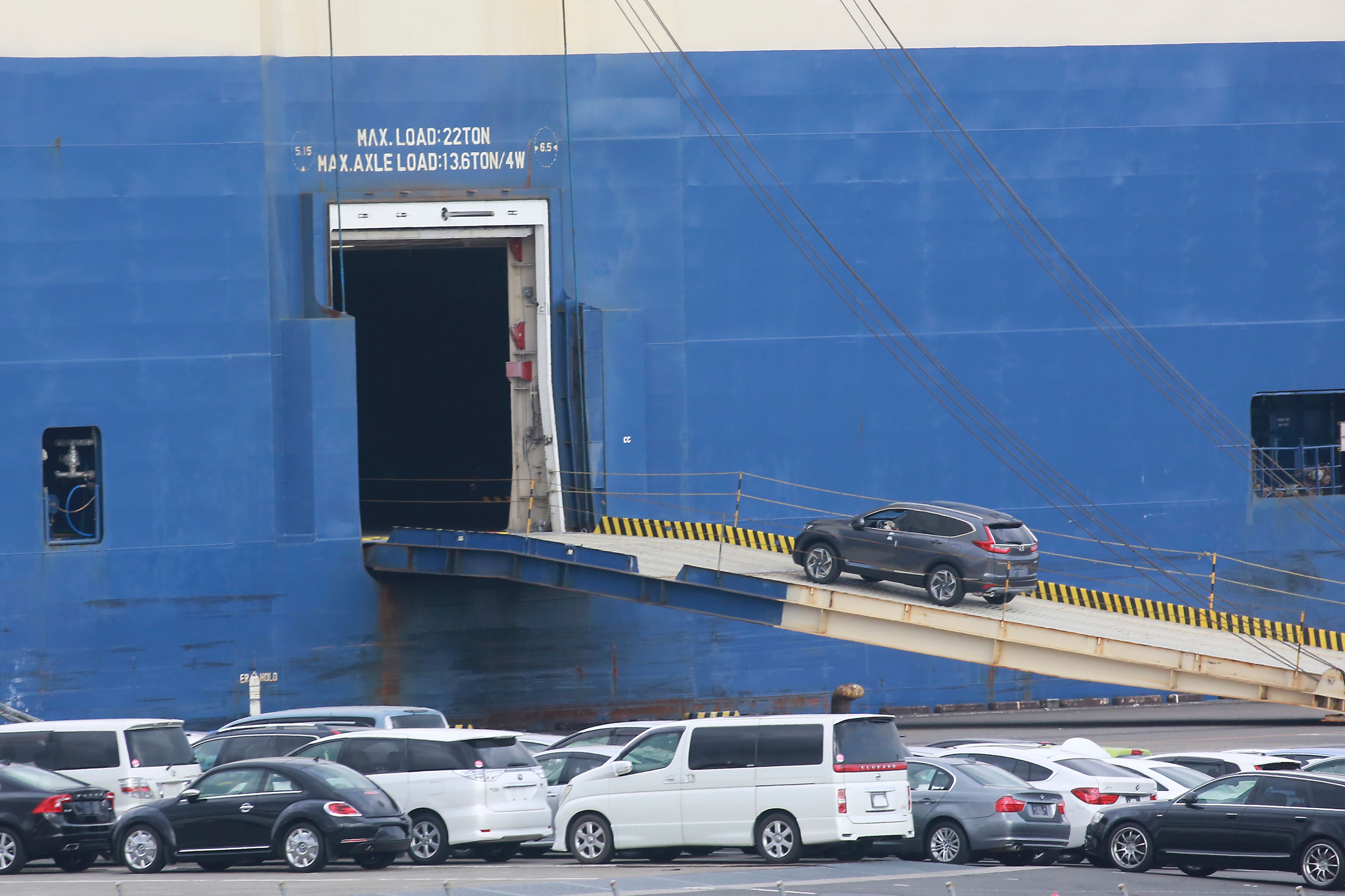 FILE - Cars for export are loaded onto a cargo ship at a port in Yokohama, near Tokyo on Nov. 2, 2021. The Japanese economy shrank at an annual rate of 1.8% in the first quarter of this year, according to government data Monday, June 10, 2024, revised to be slightly better than the initial estimate at a 2.0% contraction.