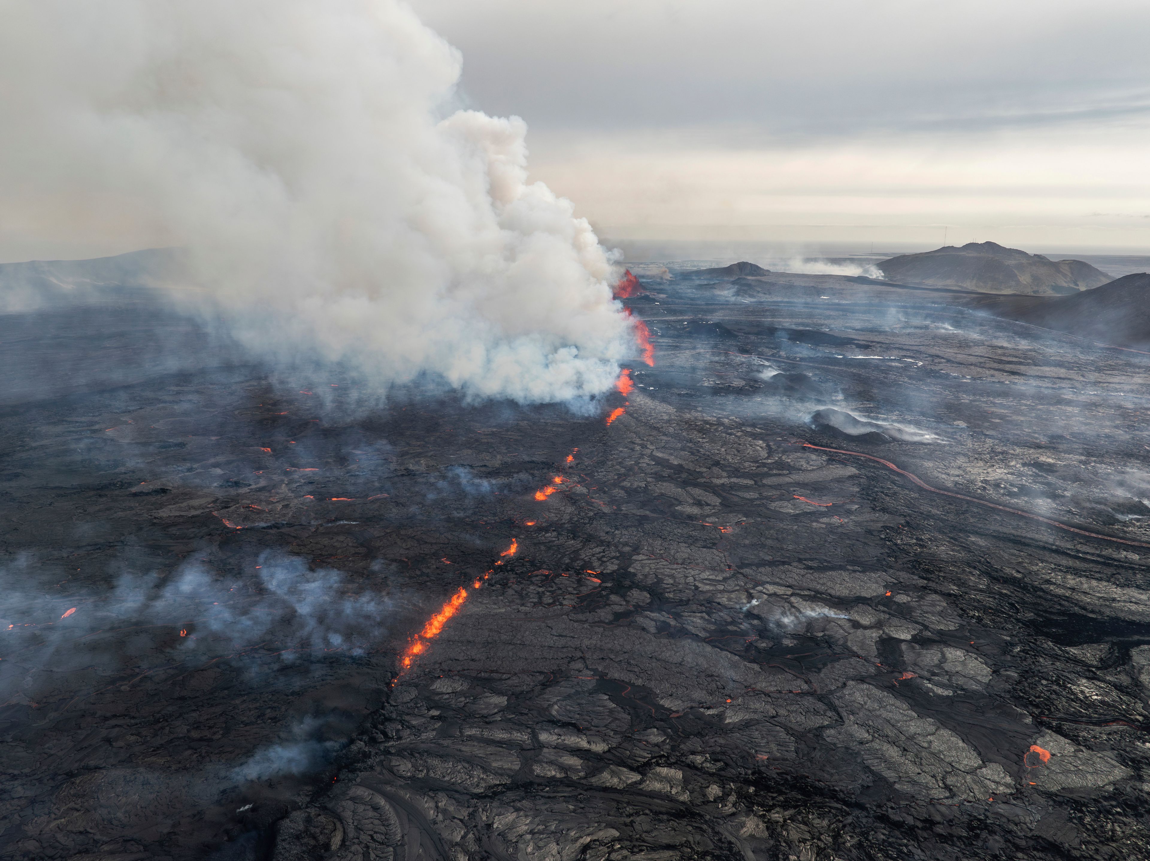 An eruptive fissure spews lava and smoke from a volcano in Grindavik, Iceland, Wednesday, May 29, 2024. A volcano in southwestern Iceland erupted Wednesday for the fifth time since December, spewing red lava that once again threatened the coastal town of Grindavik and led to the evacuation of the popular Blue Lagoon geothermal spa.