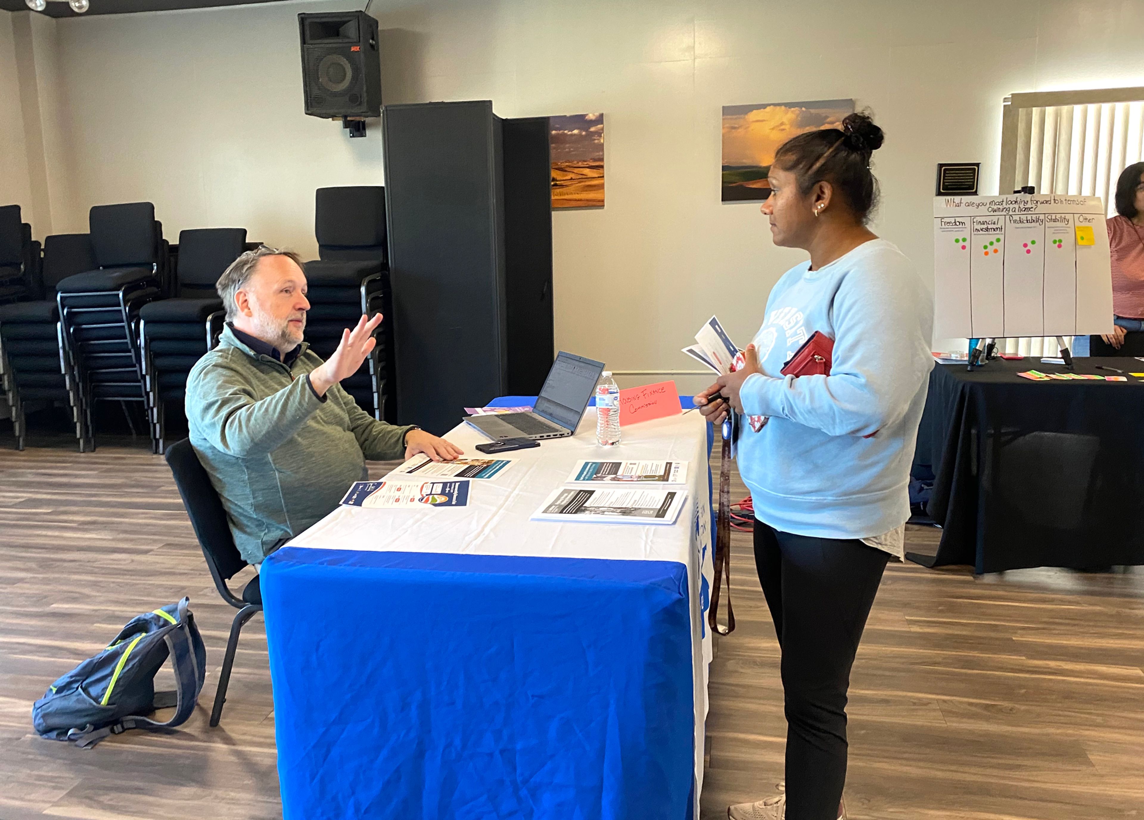 Dietrich Schmitz, left, down payment assistance program administator at the Washington State Housing Finance Commission, talked to Pullman resident Laetisha O'Rouke during the Homeownership Resource Fair on Saturday at the Gladish View Room in Pullman.