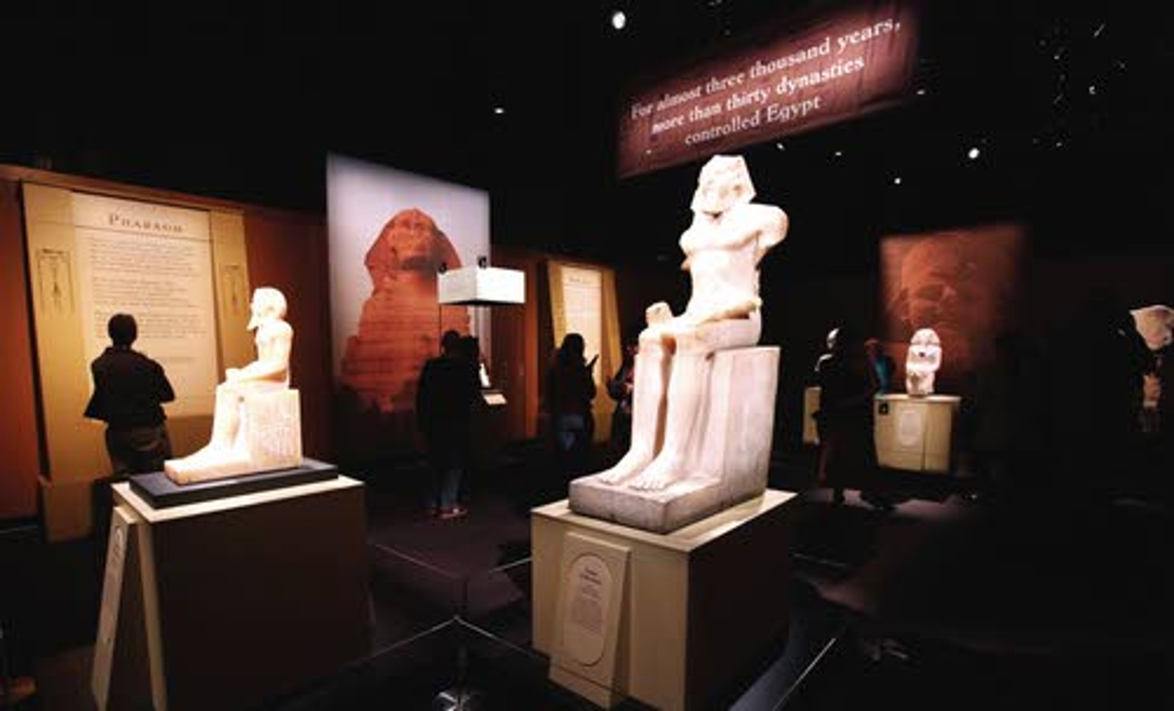 Statues greet visitors at the entrance during a preview of a King Tut exhibit on Wednesday in Seattle.