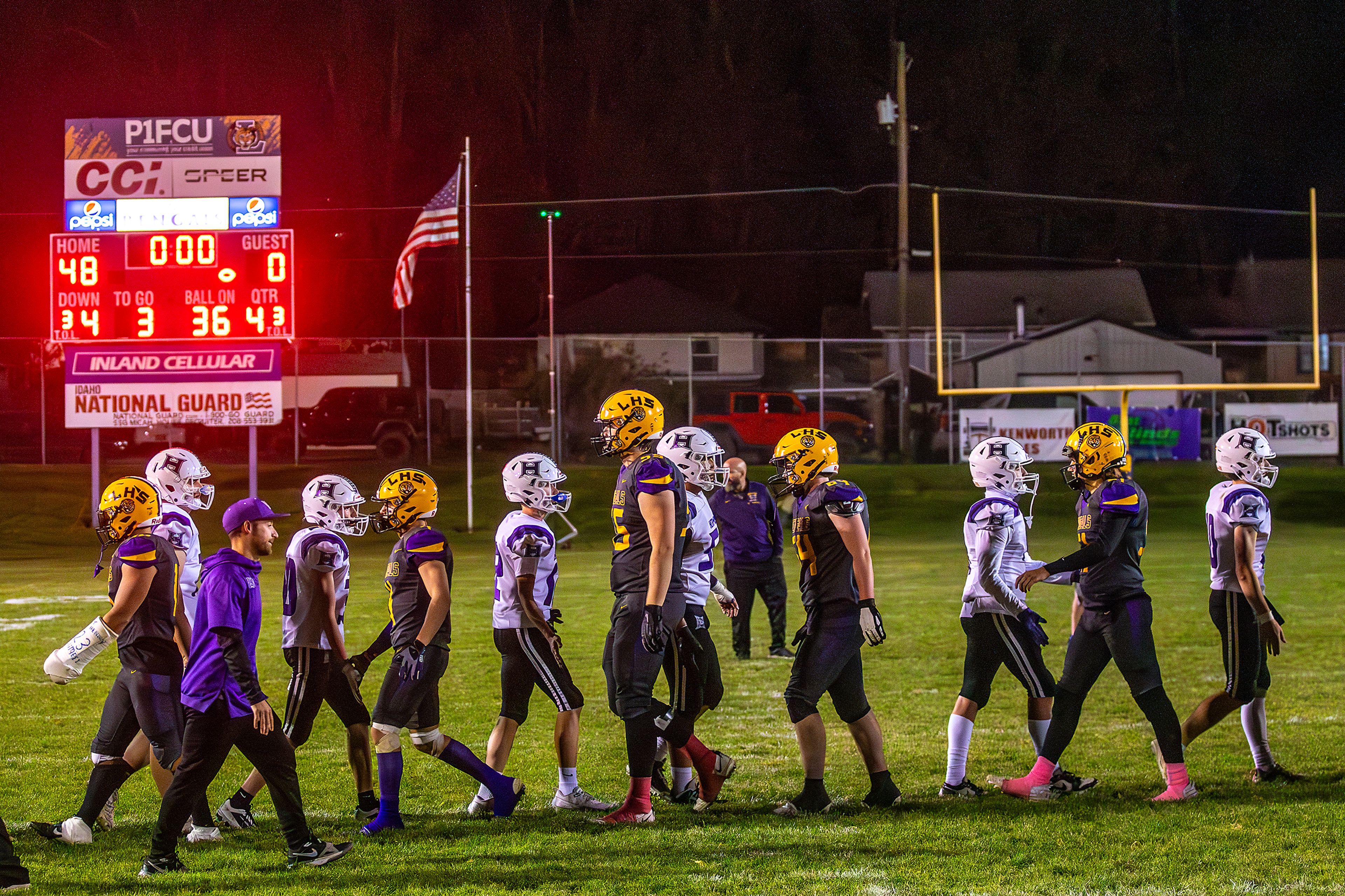 Lewiston slaps hands with Hermiston players on Bengal Field for the last time following a nonconference game at Bengal Field Friday in Lewiston.,