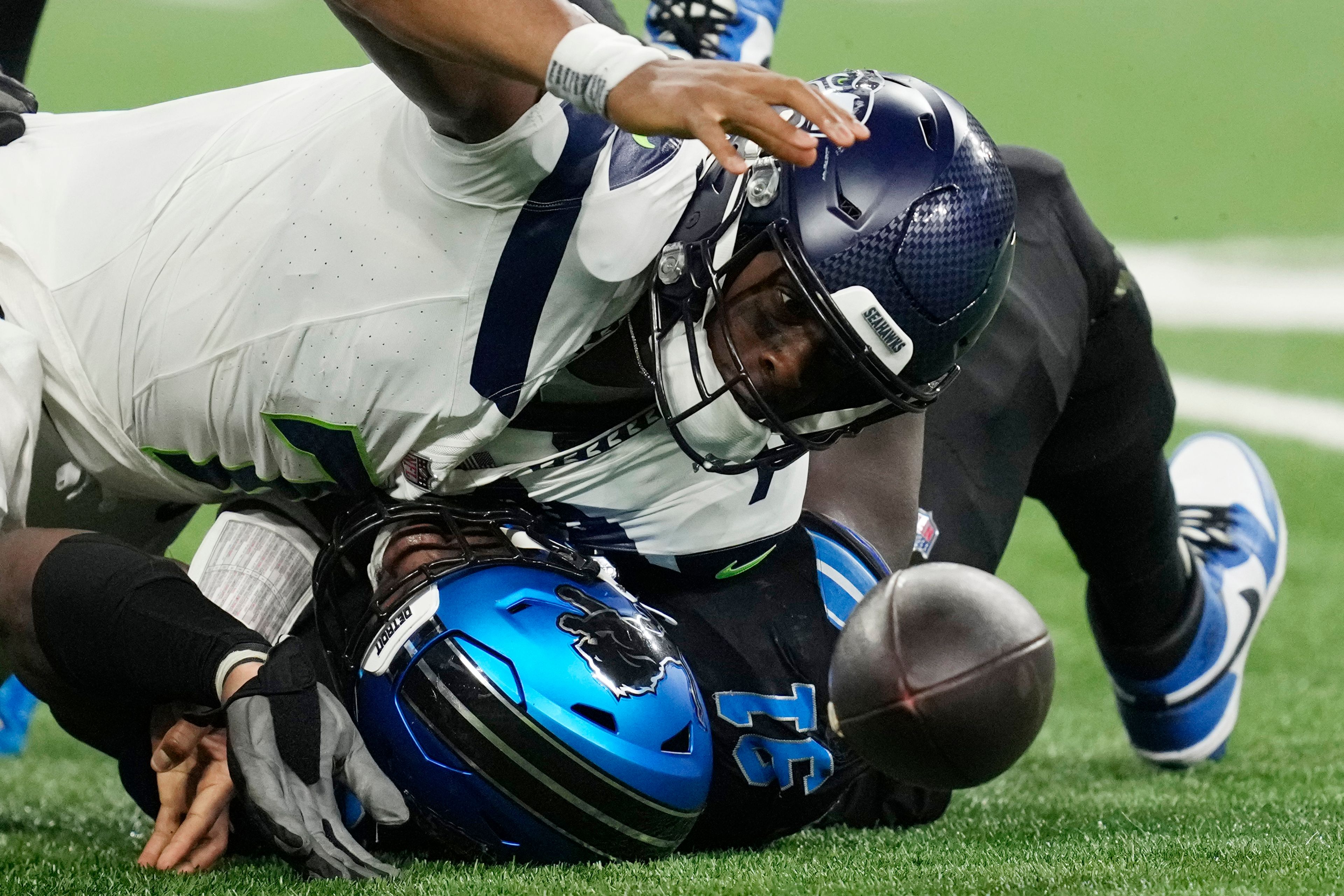 Detroit Lions defensive end Levi Onwuzurike (91) sacks Seattle Seahawks quarterback Geno Smith (7) and forces a fumble but is recovered by Smith during the second half of an NFL football game, Monday, Sept. 30, 2024, in Detroit. (AP Photo/Paul Sancya)