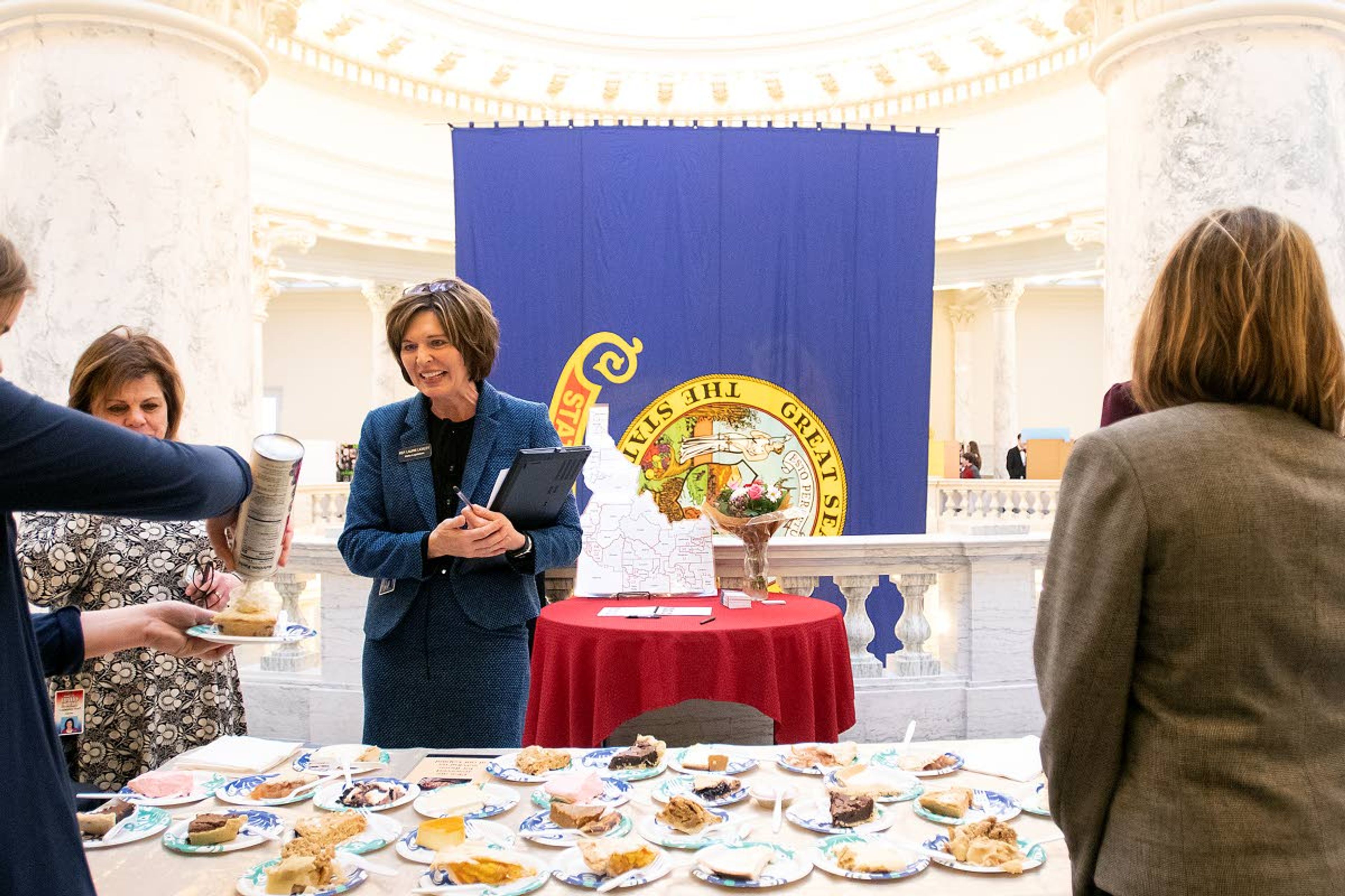 Rep. Laurie Lickley, R-Jerome, waits as homeschool students serve pie last month at the Idaho State Capitol Building. Lickley