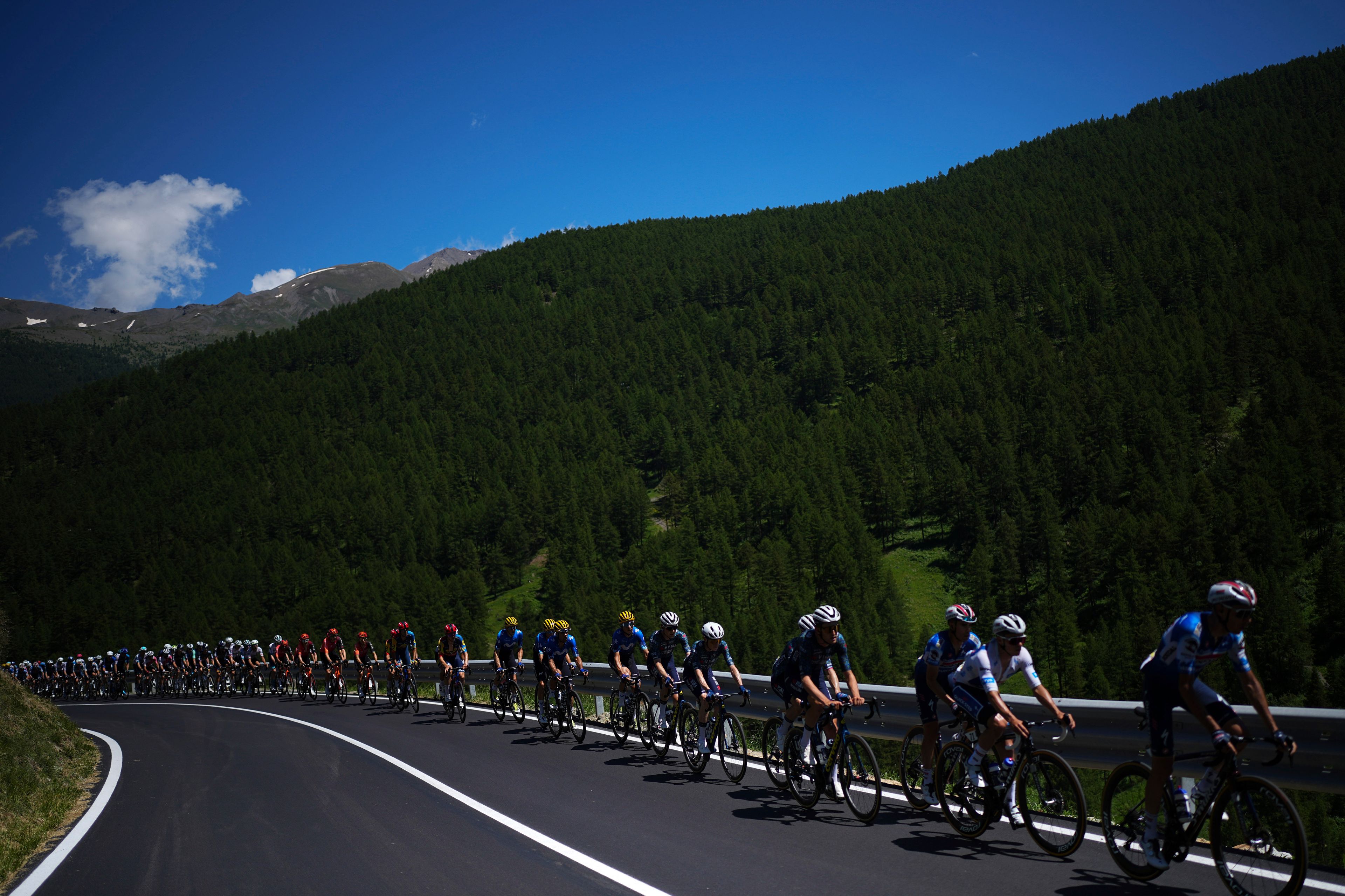 The pack rides during the fourth stage of the Tour de France cycling race over 139.6 kilometers (86.7 miles) with start in Pinerolo, Italy and finish in Valloire, France, Tuesday, July 2, 2024. (AP Photo/Daniel Cole)