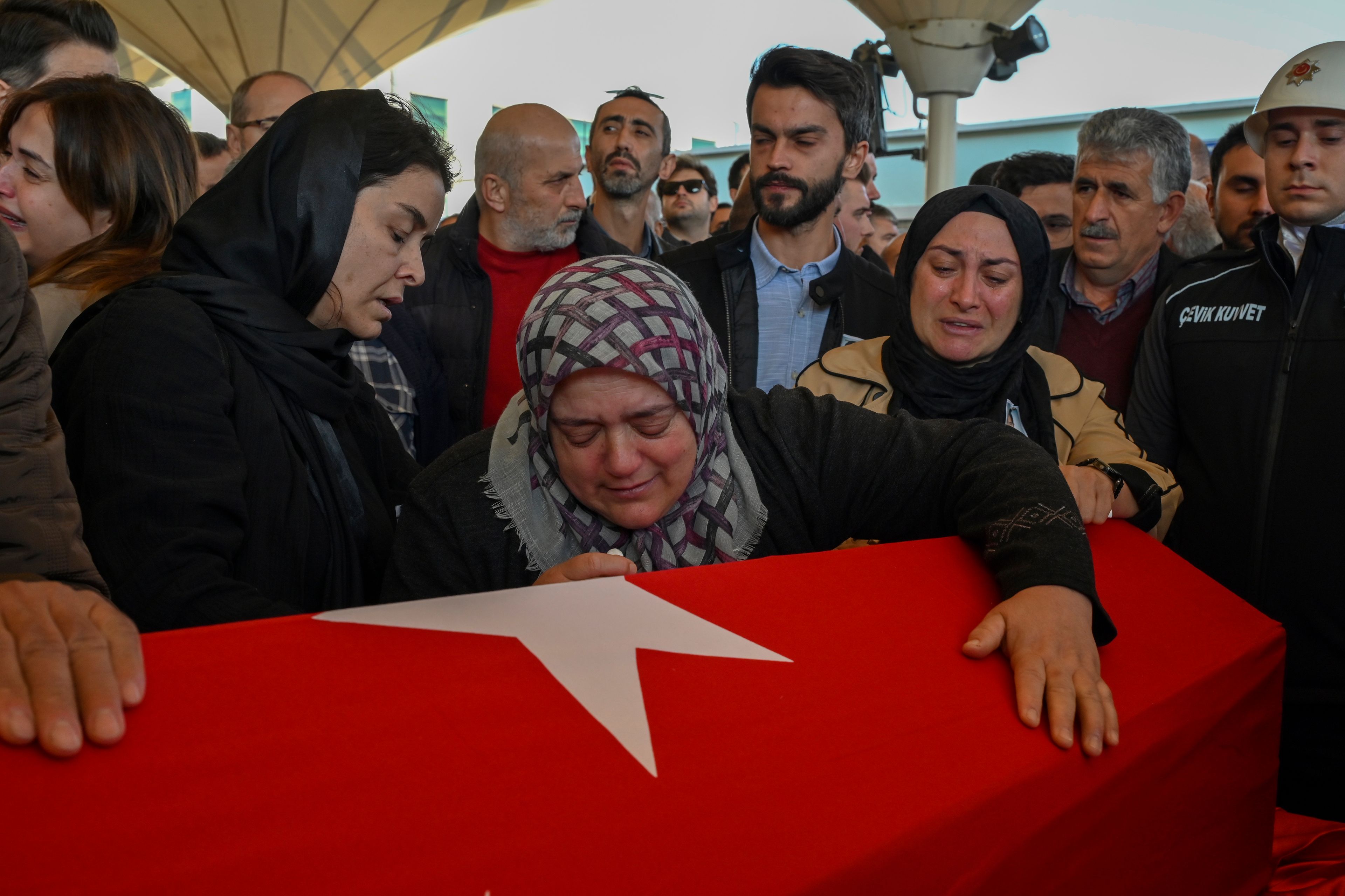 Relatives of Hasan Huseyin Canbaz, who was killed during an attack by PKK members at the Turkish aerospace and defense company TUSAS in Ankara on Wednesday, mourn during a funeral at Karsiyaka morgue in Ankara, Thursday, Oct. 24, 2024. (AP Photo/Ali Unal)