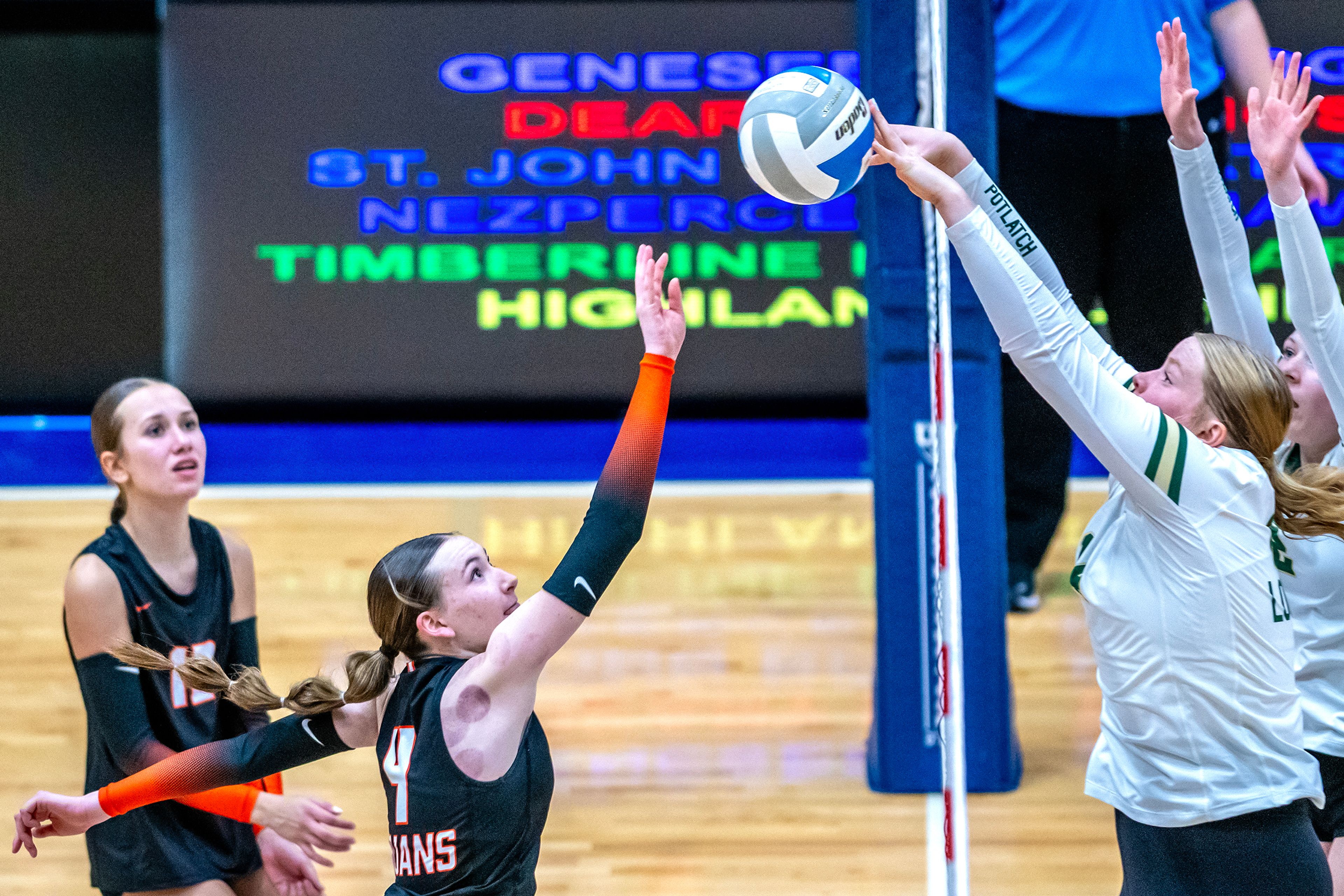 Potlatch middle blocker Kathy Burnette tips down Troy outside hitter Tessa Stoner's hit during a 2A district championship Wednesday at the P1FCU Activity Center in Lewiston.