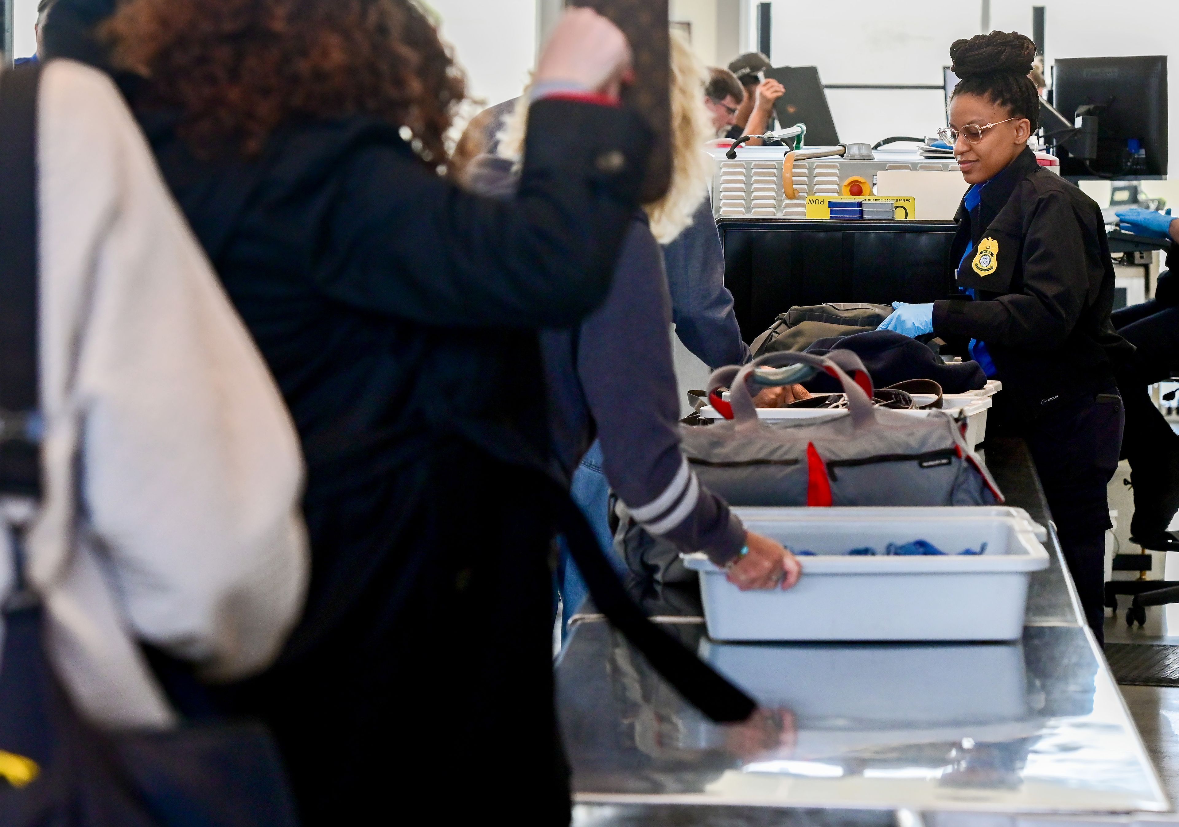 TSA agents help people through their security lanes in the new Pullman-Moscow Regional Airport terminal in Pullman on Wednesday.